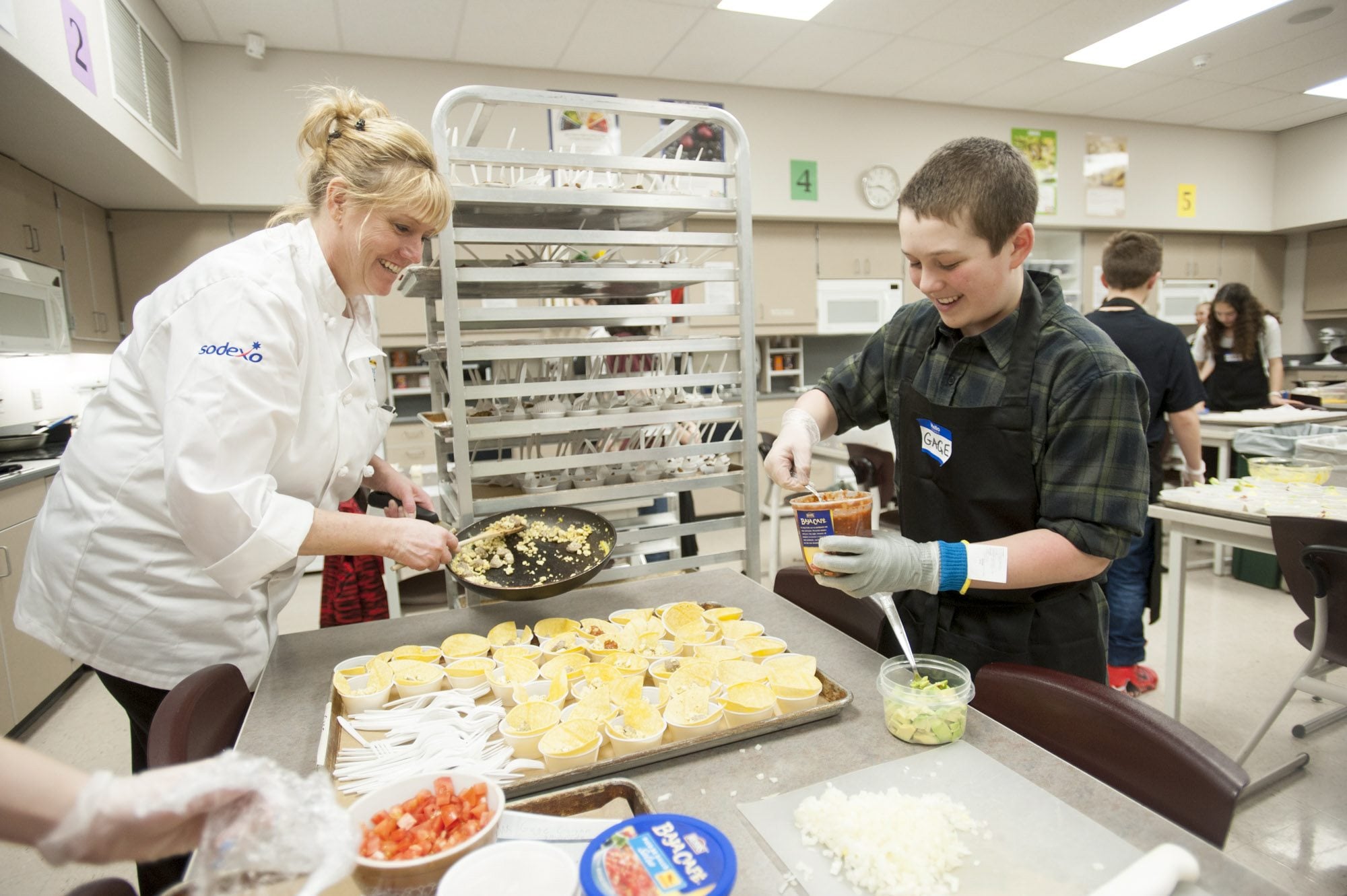 Skyridge Middle School eighth-grader Gage Gywnn gets some help from Robin Boespflug as he assembles samples of his recipe, &quot;Breakfast Taco,&quot; for the Future Chef contest Tuesday afternoon at Camas High School. Gage took home the top prize for his heart-healthy breakfast dish.