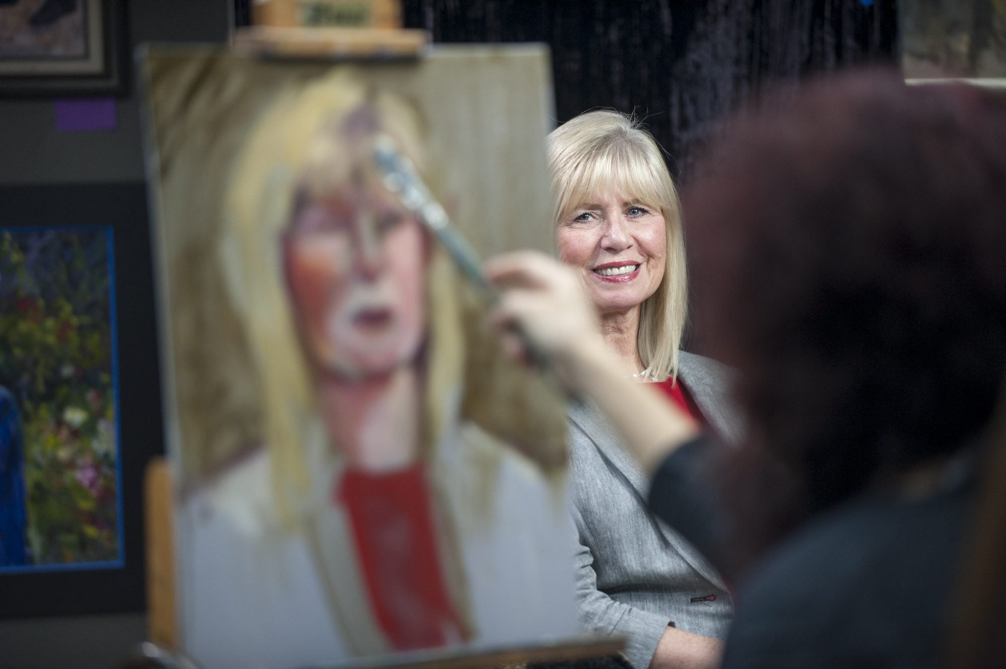 Local artist Hilarie Couture works on Linda Glover&#039;s portrait as part of an art project recognizing 40 notable Clark County women, past and present.