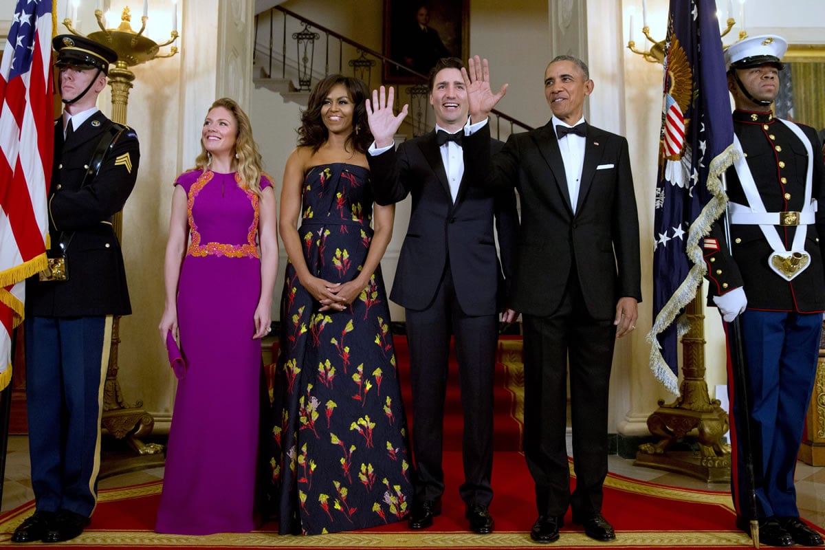 President Barack Obama, right, and Canadian Prime Minister Justin Trudeau, both wave next to Sophie Gregoire Trudeau, left, and first lady Michelle Obama on Thursday during a State Dinner at the White House.
