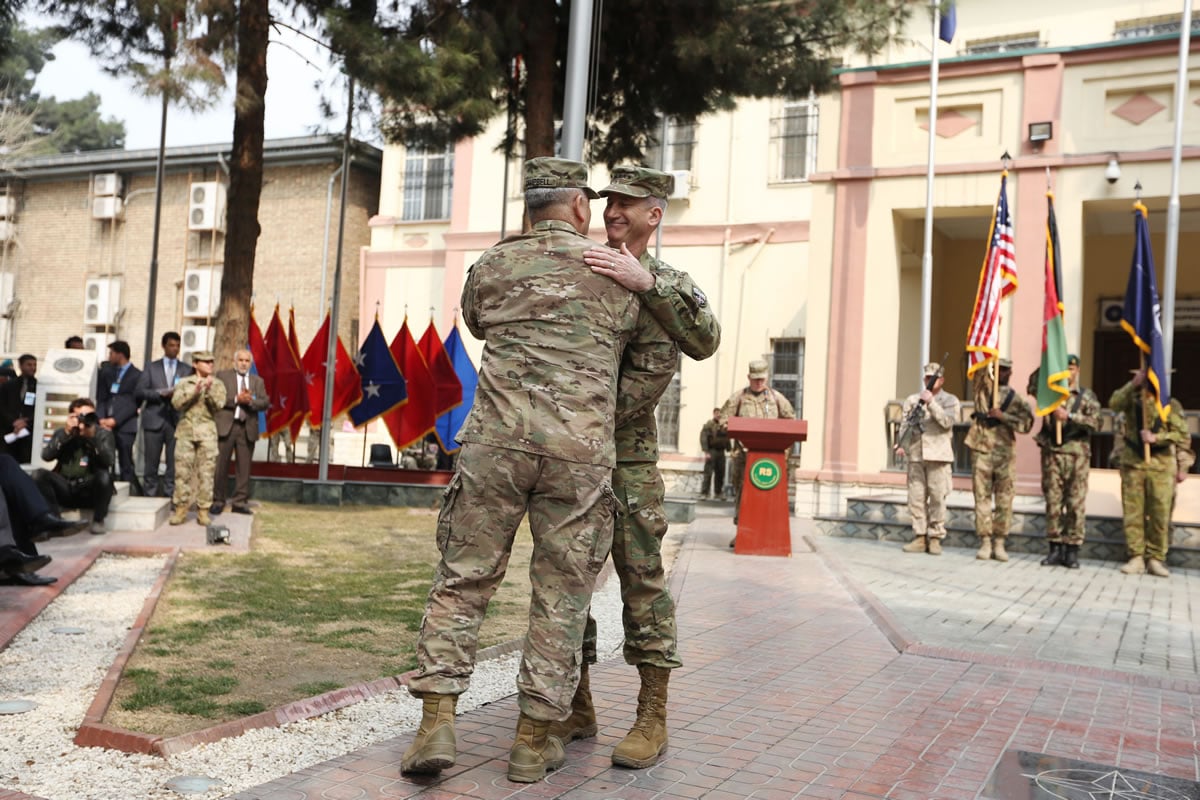 Army Gen. John Campbell, left, outgoing commander of Resolute Support forces and United States forces in Afghanistan, and incoming commander Gen. John Nicholson embrace during a change of command ceremony Wednesday at Resolute Support headquarters in Kabul, Afghanistan.