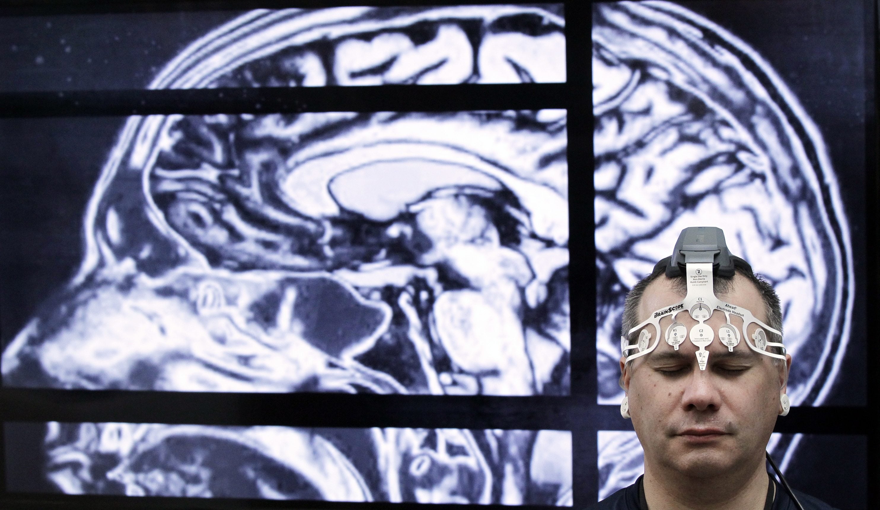 BrainScope employee Doug Oberly wears a brain scanning headset at the NFL owners' meeting in Boca Raton, Fla., Tuesday, March 22, 2016. The headset and mobile app can quickly and easily allow clinicians to determine whether patients have sustained a traumatic brain injury (TBI), the company says. (AP Photo/Luis M.
