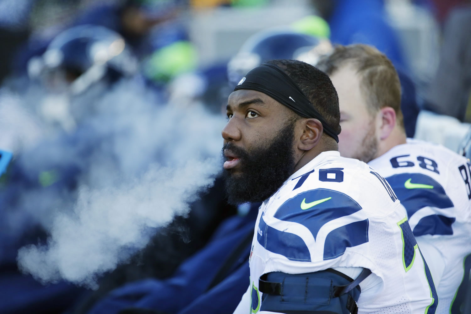 FILE - In this Sunday, Jan. 10, 2016 file photo, Seattle Seahawks tackle Russell Okung (76) sits on the bench during the second half of an NFL wild-card football game against the Minnesota Vikings in Minneapolis. John Elway bolstered both his offensive line and his already strong reputation as one of the NFL?s best general managers Thursday, March 17, 2016 by luring former Seattle Seahawks left tackle Russell Okung to the Denver Broncos.(AP Photo/Nam Y.