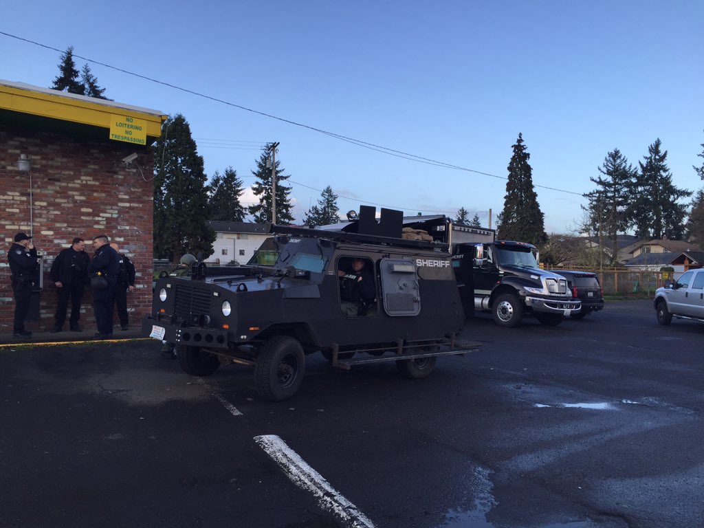 A SWAT vehicle is parked at the incident command post, Everyday Deals General Liquidators, following an incident where shots were fired at officers near Washington Elementary School.