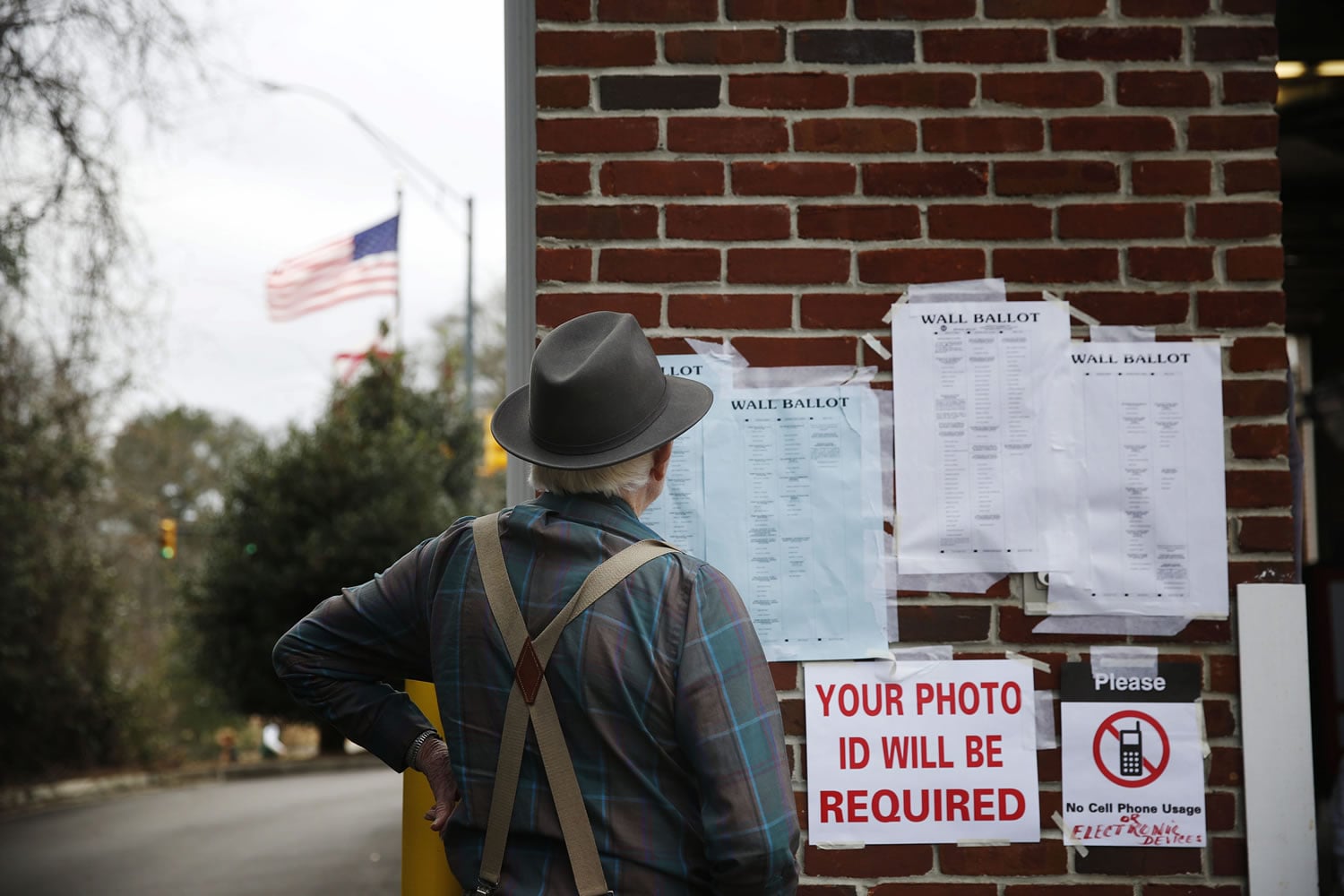 A voter looks for voting information before he cast his ballot in the Alabama&#039;s primary at a polling site, Tuesday, March 1 in Birmingham, Ala.  Voters from Vermont to Colorado, Alaska to American Samoa and a host of states in between were heading to polling places and caucus sites on the busiest day of the 2016 primaries.