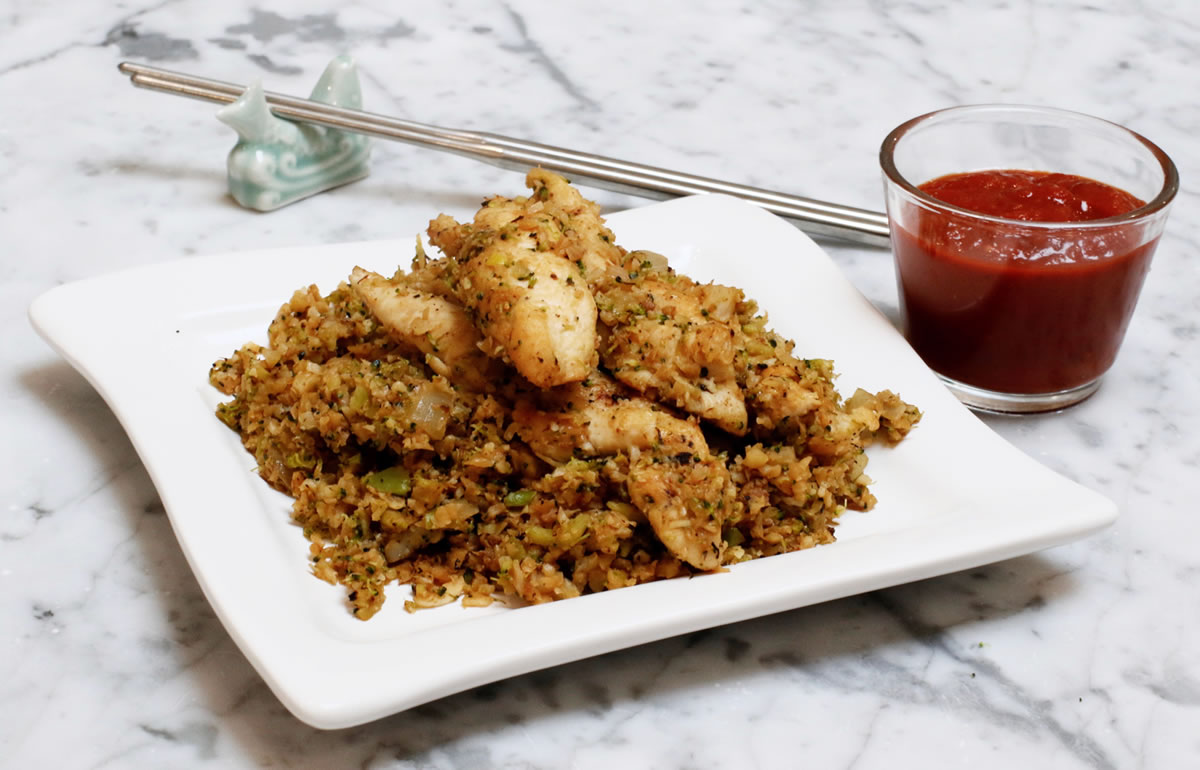 A serving of Italian stir-fry with seared chicken breast and marinara. Finely chopped broccoli and cauliflower stand in for the rice in this vegetable-forward version of the classic Asian dish. (AP Photo/J.M.