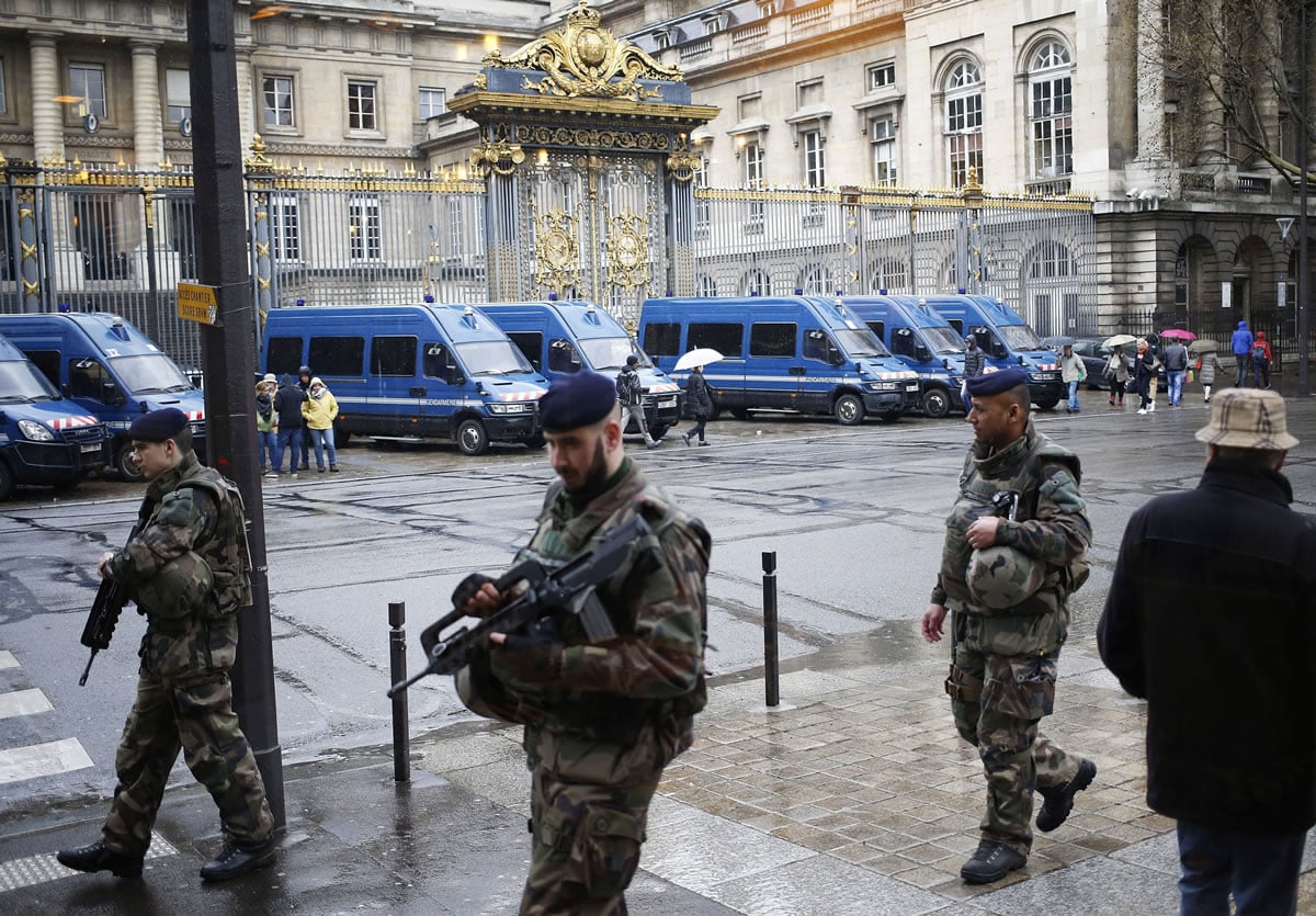 French soldiers patrol outside the Paris hall of Justice, Wednesday, March 30, 2016 while Frenchman Reda Kriket  is being questioned by a magistrate who is expected to file preliminary terrorism charges.  Kriket has been detained in the Paris region last week on suspicion of being in the &quot;advanced stages&quot; of a plot. Authorities found a large quantity of explosives and weapons in Kriket&#039;s apartment.
