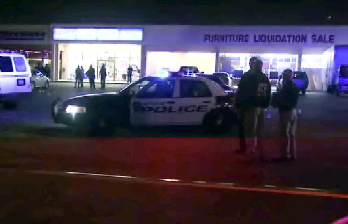 This still image taken from video provided by KPRC shows police responding Thursday to the scene of a shooting in Houston. Police fired at five suspected robbers Thursday night outside the furniture store, killing two and injuring two other members of the group, which was being monitored by a tactical team investigating other robberies earlier in the day.