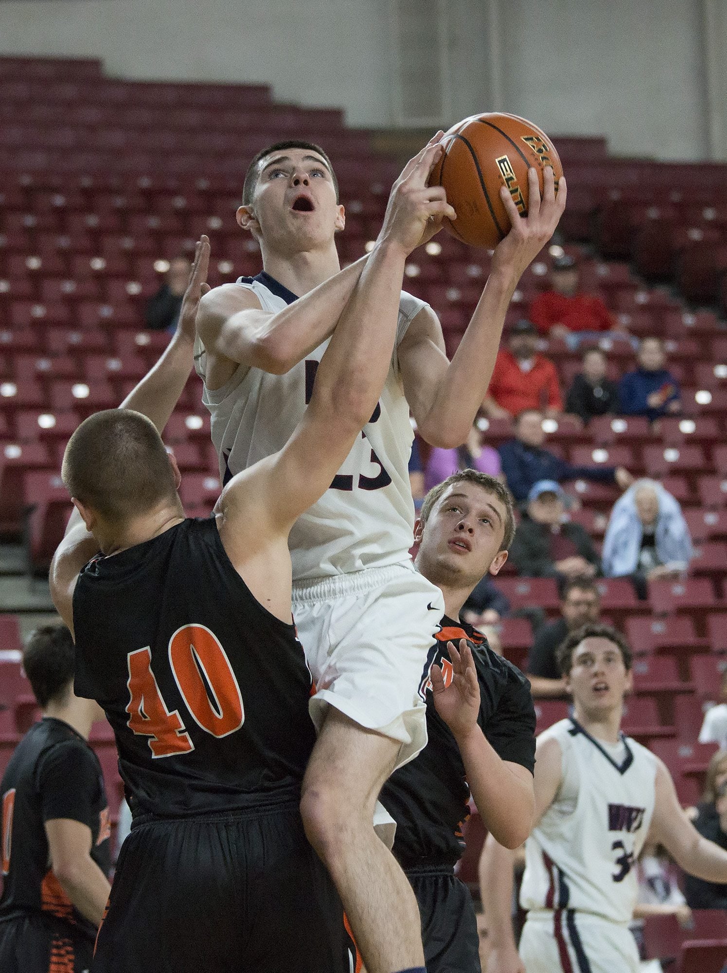 King’s Way Christian High School’s Kienan Walter drives to the basket against the defense of Kalama High School’s Hunter Esary in the first half of their game in the boys’ class 1A state basketball tournament March 5, 2016 in the Yakima SunDome in Yakima, Wash. Kalama won the game 56-41.