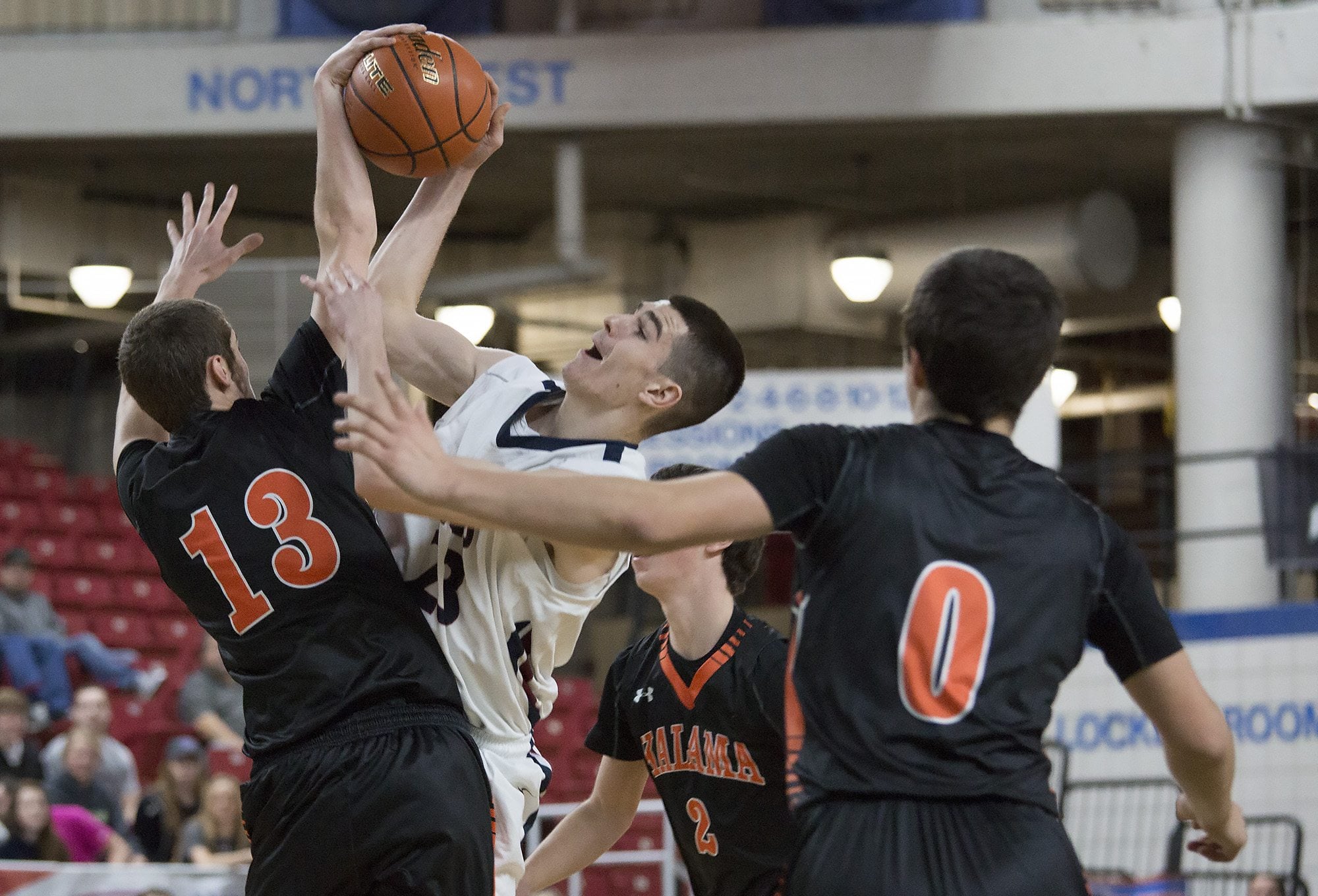 King’s Way Christian High School’s Kienan Walter, center, has his shot blocked by Kalama High School’s Austin Dines in the first half of their game in the boys’ class 1A state basketball tournament March 5, 2016 in the Yakima SunDome in Yakima, Wash.