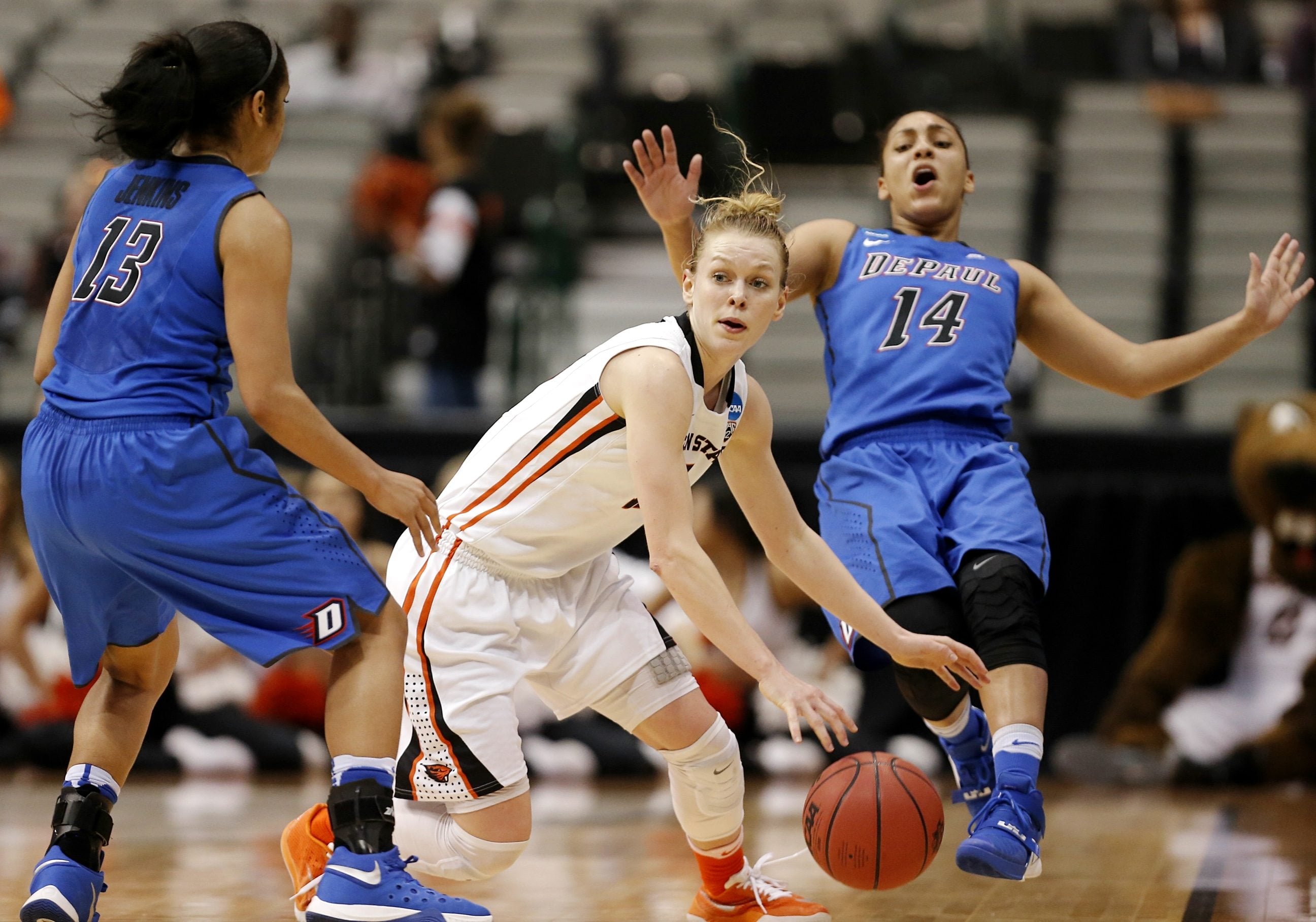 Oregon State guard Jamie Weisner, center, looks for room against DePaul guards Chanise Jenkins (13) and Jessica January (14) during the second half of an NCAA college basketball game in the regional semifinals of the women's NCAA Tournament Saturday, March 26, 2016, in Dallas.