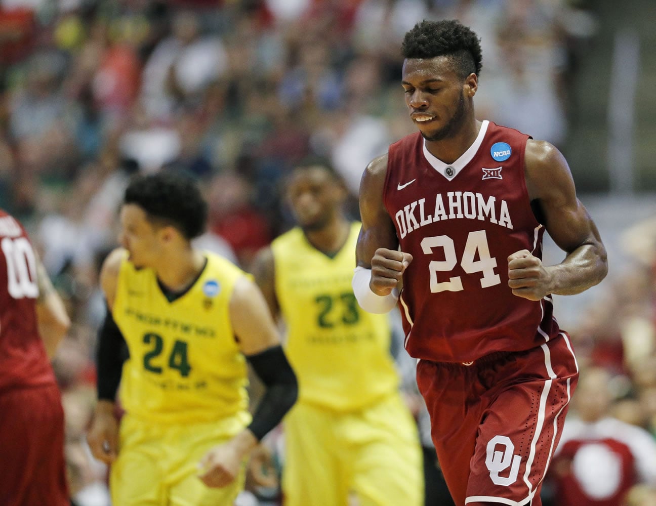 Oklahoma guard Buddy Hield celebrates after scoring during the second half of an NCAA college basketball game against Oregon in the regional finals of the NCAA Tournament, Saturday, March 26, 2016, in Anaheim, Calif.