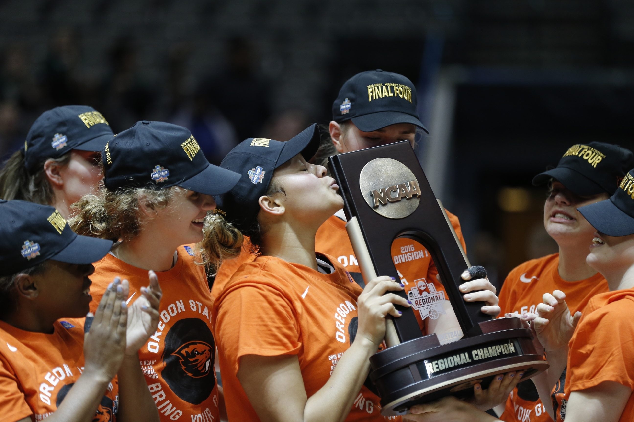 Oregon State forward Deven Hunter, center, kisses the Division I Regional Championship NCAA trophy after a women's NCAA basketball tournament  game against Baylor Monday, March 28, 2016, in Dallas. Oregon State won 60-57.