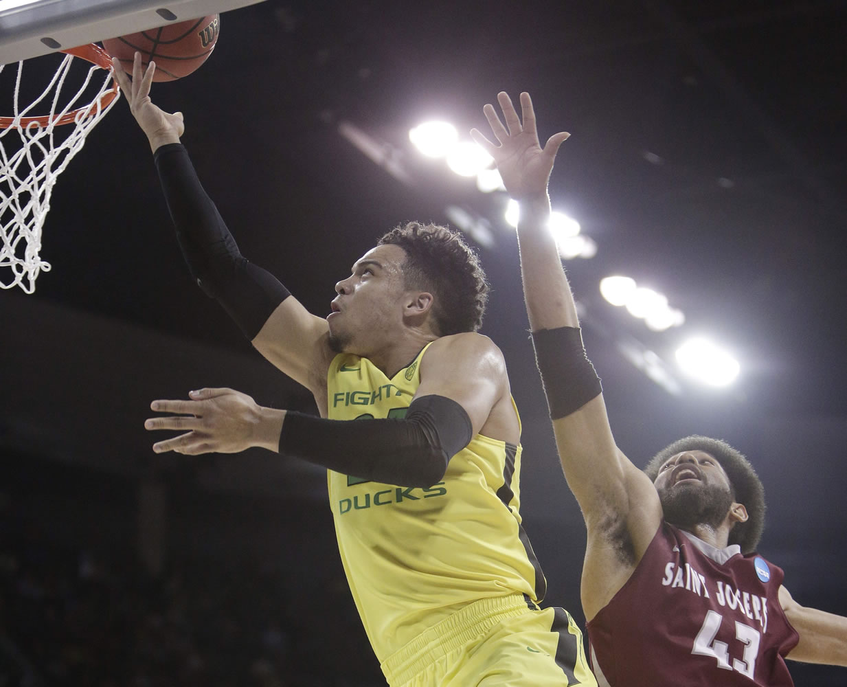Oregon forward Dillon Brooks, left, shoots against Saint Joseph's forward DeAndre Bembry (43) during the first half of a second-round men's college basketball game in the NCAA Tournament in Spokane, Wash., Sunday, March 20, 2016.