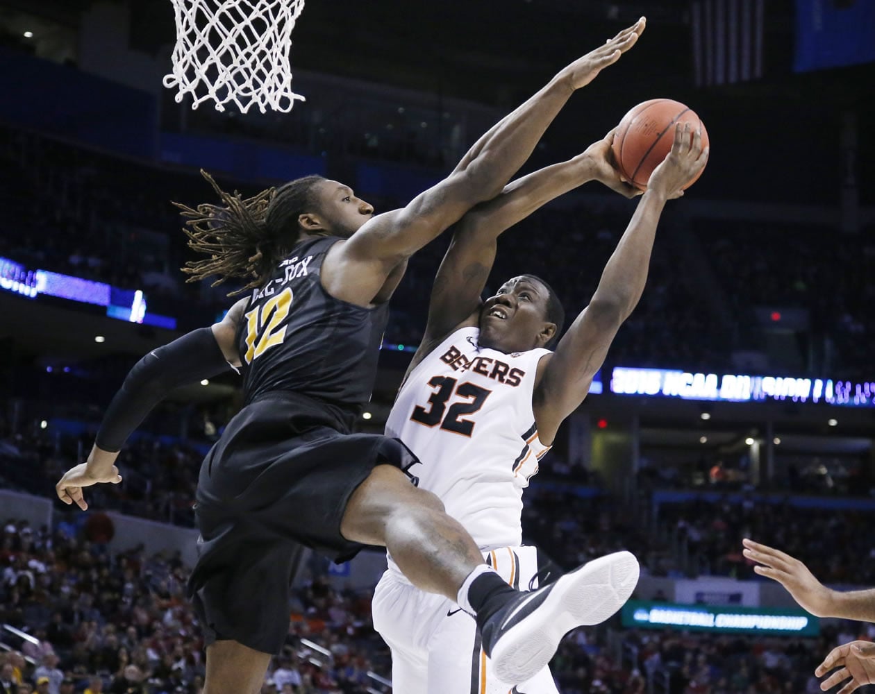 Oregon State forward Jarmal Reid (32) shoots as Virginia Commonwealth forward Mo Alie-Cox (12) defends in the second half of a first-round men's college basketball game in the NCAA Tournament, Friday, March 18, 2016, in Oklahoma City. VCU won 75-67.