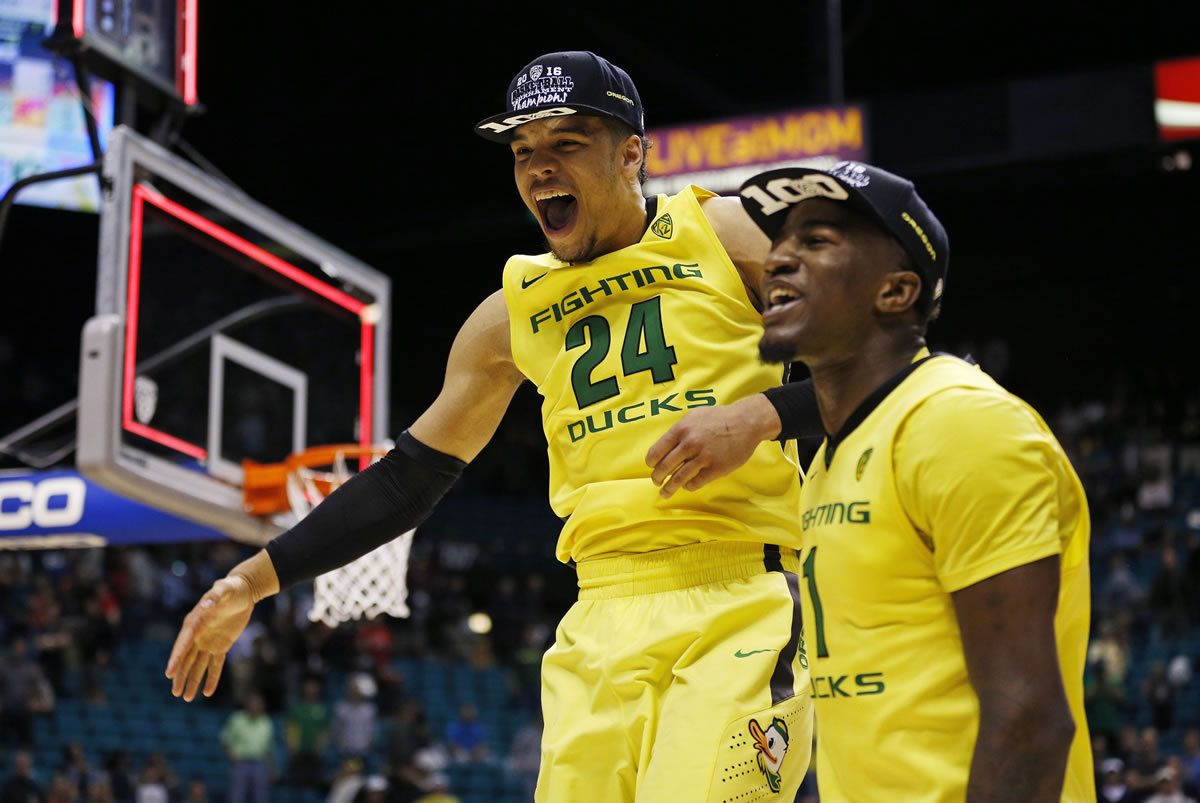 Oregon forward Dillon Brooks (24) and forward Jordan Bell celebrate after they defeated Utah in an NCAA college basketball game in the championship of the Pac-12 men's tournament Saturday, March 12, 2016, in Las Vegas. Oregon won 88-57.
