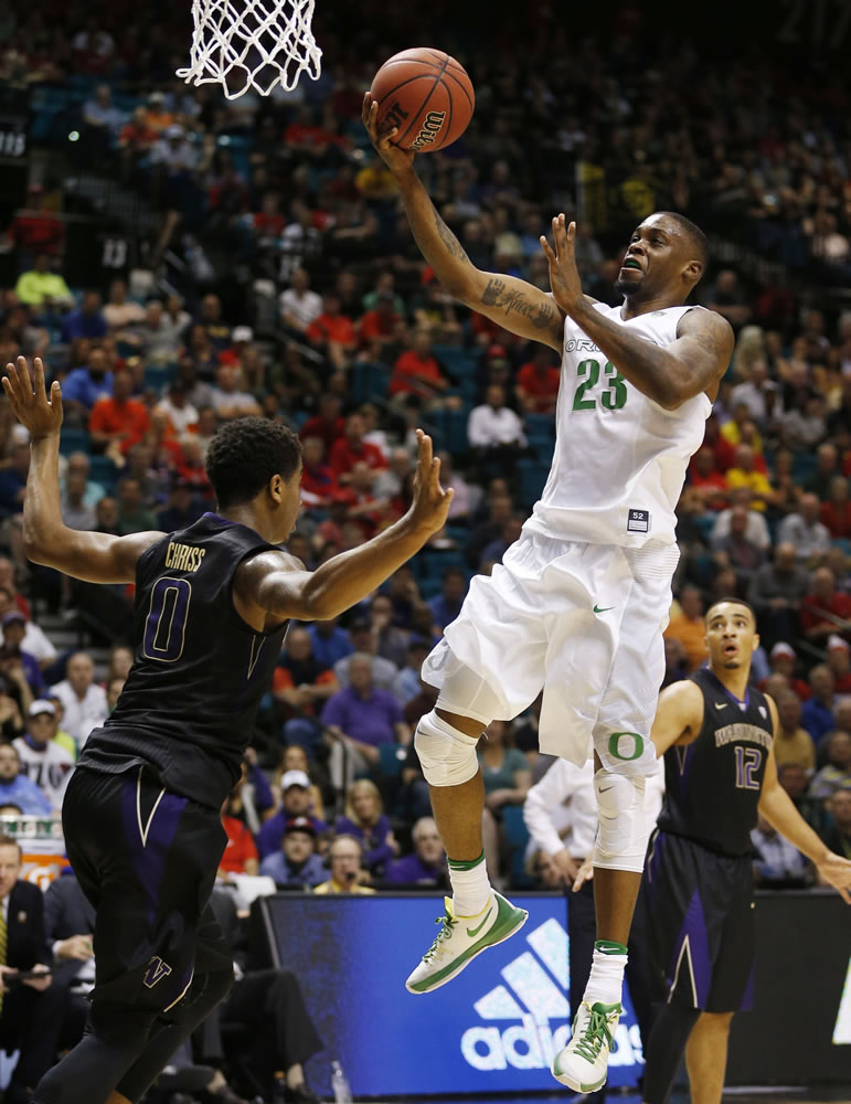 Oregon forward Elgin Cook shoots over Washington forward Marquese Chriss during the second half of an NCAA college basketball game in the quarterfinal round of the Pac-12 men's tournament Thursday, March 10, 2016, in Las Vegas. Oregon won 83-77.