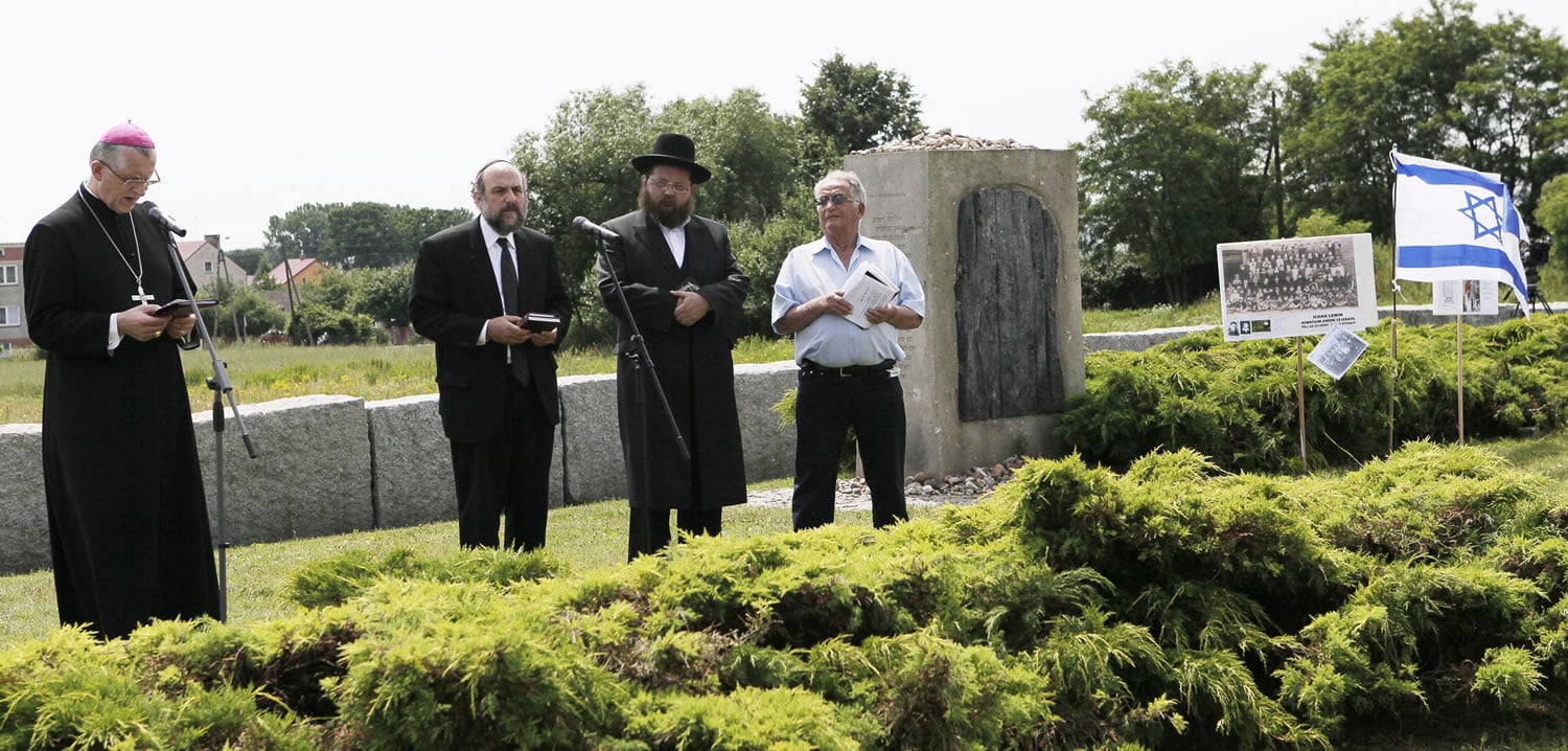 Roman Catholic Bishop Mieczyslaw Cislo, left, Chief Rabbi of Poland Michael Schudrich, second left, kantors Symkha Keller and Icchak Levi honor the Jewish victims of Jedwabne, who were killed in 1941, during World War II, by their Polish neighbors, in Jedwabne, Poland.
