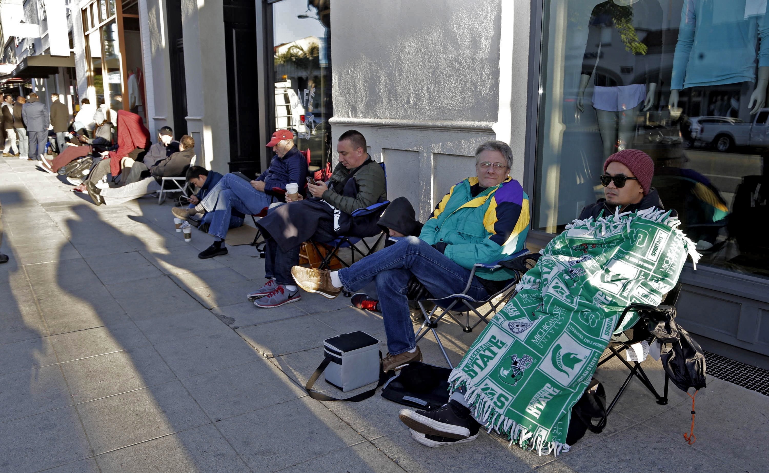 Customers wait in line to be the first to sign a wait list to own the new Tesla Model 3 on Thursday at the Tesla showroom in Pasadena, Calif.