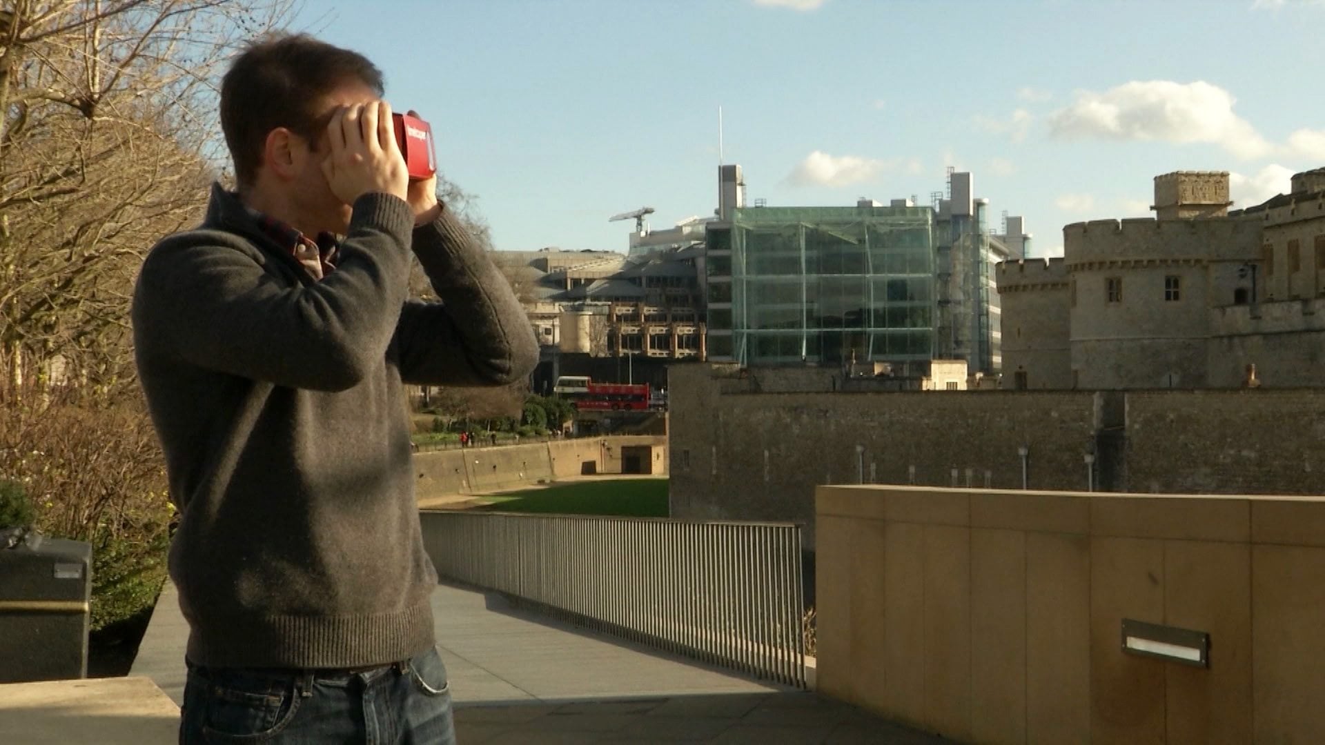 Timelooper co-founder Andrew Feinberg looks through a Google cardboard virtual reality headset across from the Tower of London in London, England, on Feb. 2. The Timelooper app allows users to experience key moments in London history with just a smartphone and a cardboard headset.