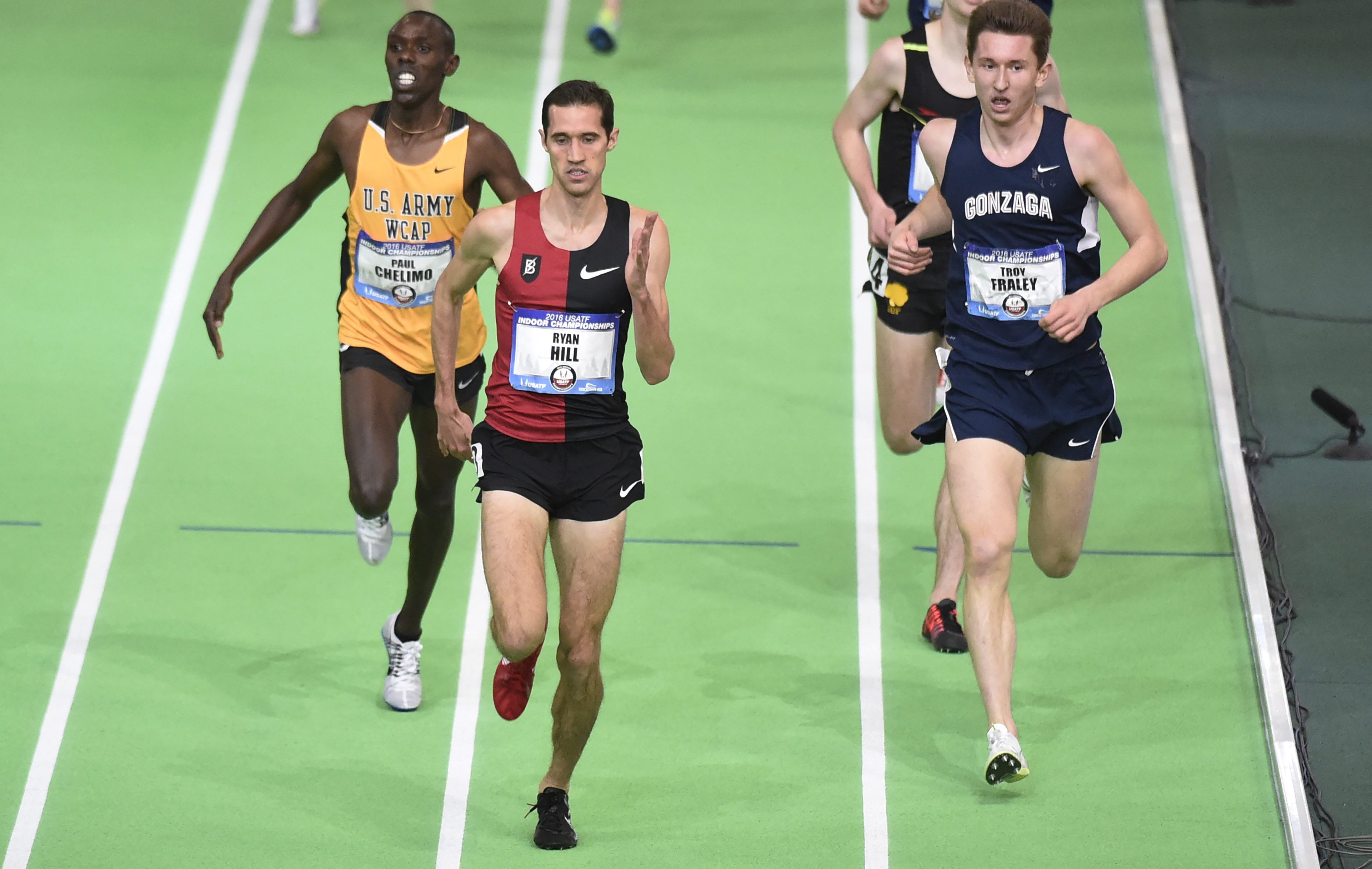 Ryan Hill beats Paul Chelimo, left, to the finish line to win the men&#039;s 3,000 meters as Troy Faley, right, gets lapped at the U.S. indoor track and field championships in Portland, Ore., Friday, March 11, 2016.