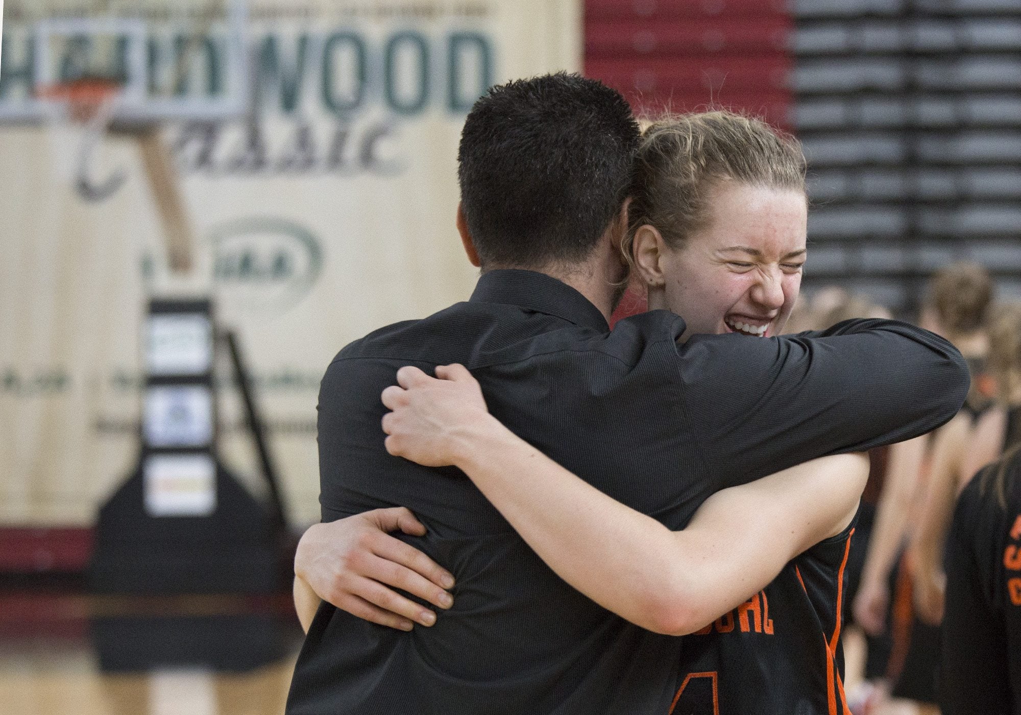 Washougal High School’s Raeann Allen hugs her coach Brian Oberg in celebration after Washougal beat Black Hills High School 50-28 in the class 2A girls Hardwood Classic state basketball tournament March 5, 2016 in the Yakima SunDome in Yakima, Wash. The win earned Washougal fourth place in the tournament.