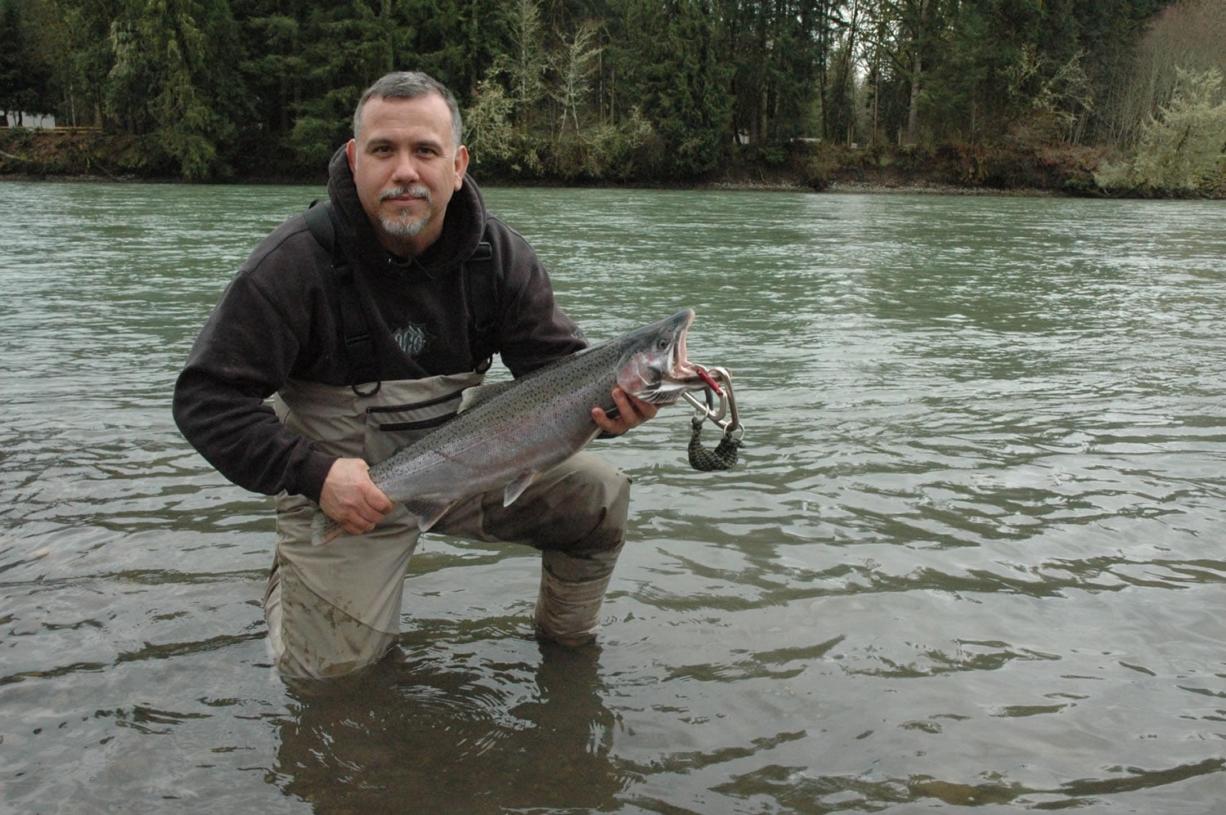 Frank Adams of Orting, Wash., holds a winter steelhead he caught in the Cowlitz River near the trout hatchery.