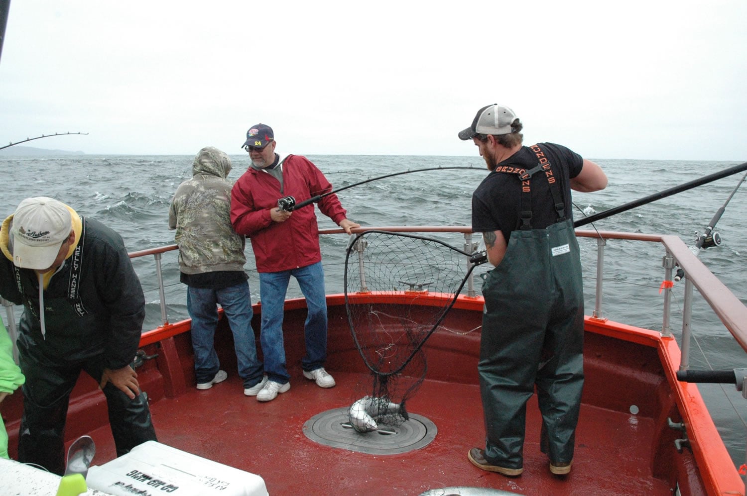 Deckhand Donald Pitts nets a salmon for a charter boat customer in 2014 in the Pacific Ocean off Ilwaco.