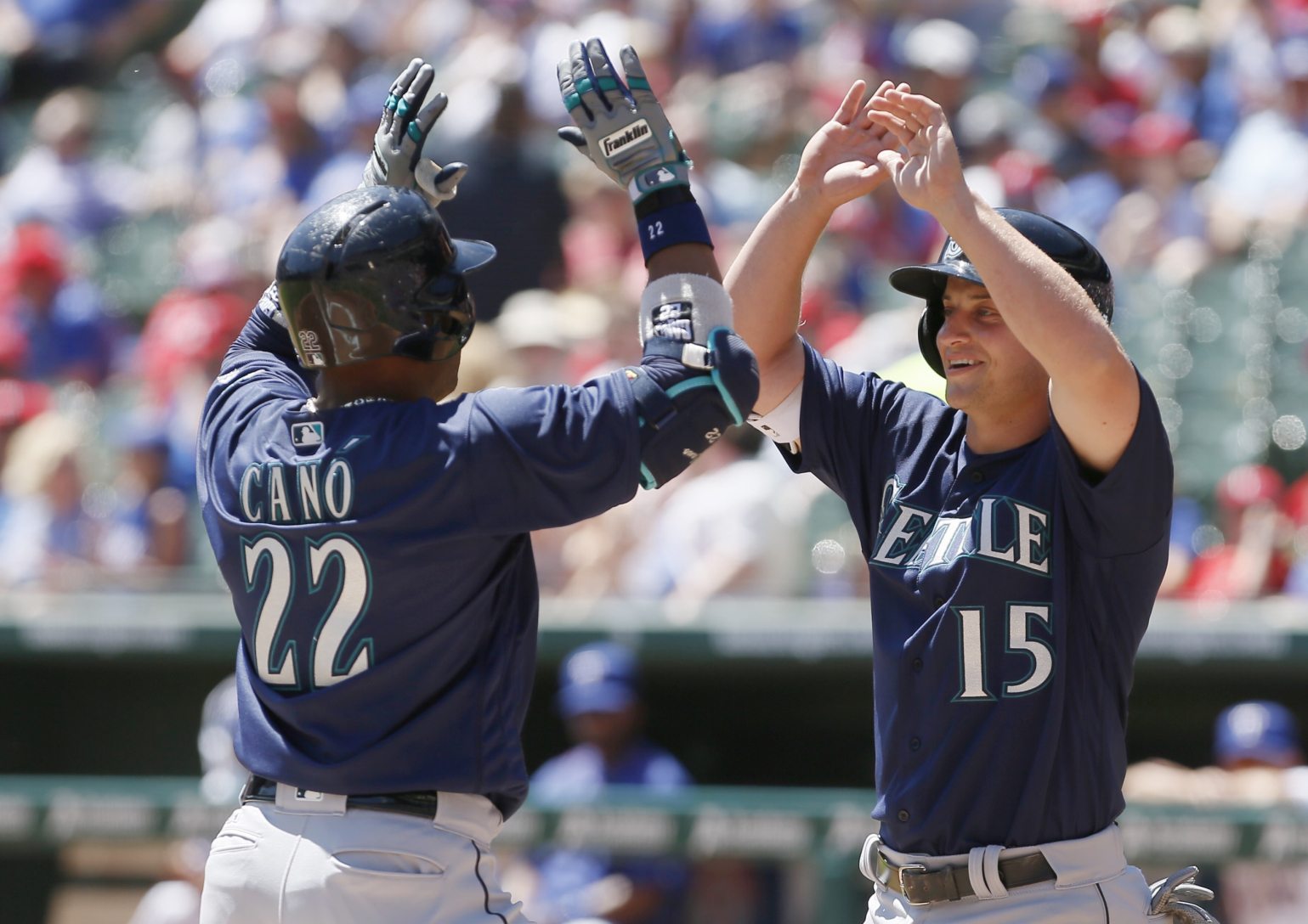 Seattle Mariners&#039; Robinson Cano (22) is congratulated by Kyle Seager (15) after hitting a two run home run during the first inning of a baseball game against the Texas Rangers Wednesday, April 6, 2016, in Arlington, Texas.