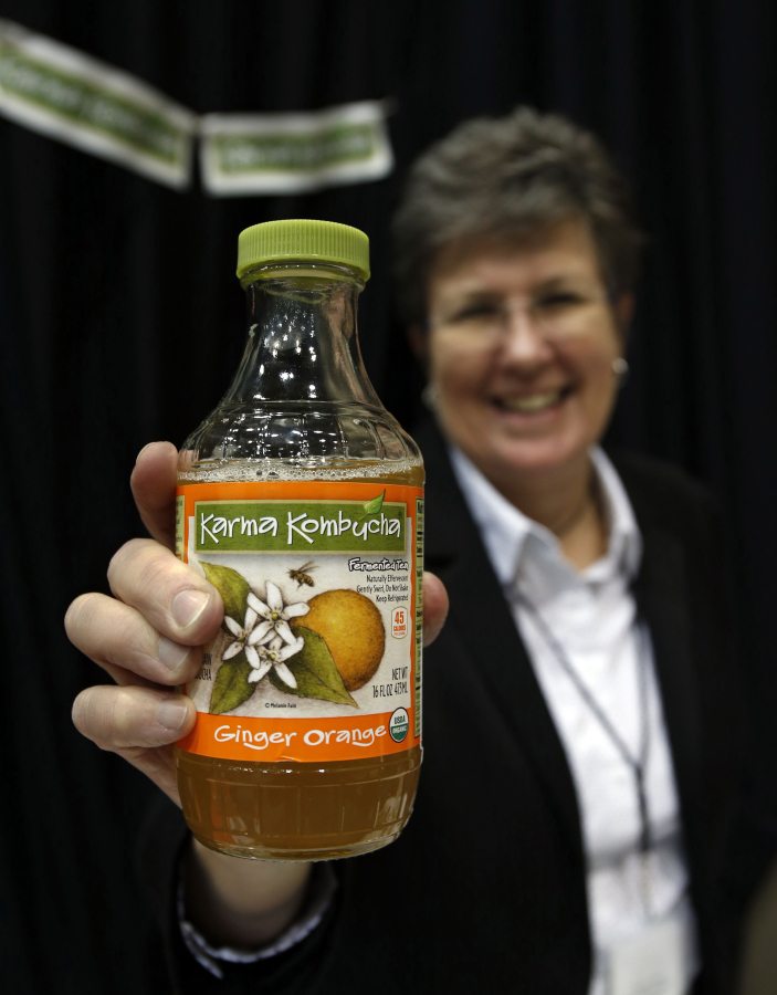 Susan Fink, founder and brewer of Karma Kombucha, holds a bottle of her Ginger Orange kombucha beverage at the Good Food Festival&#039;s financing and innovation conference on March 24 at the UIC Forum in Chicago.