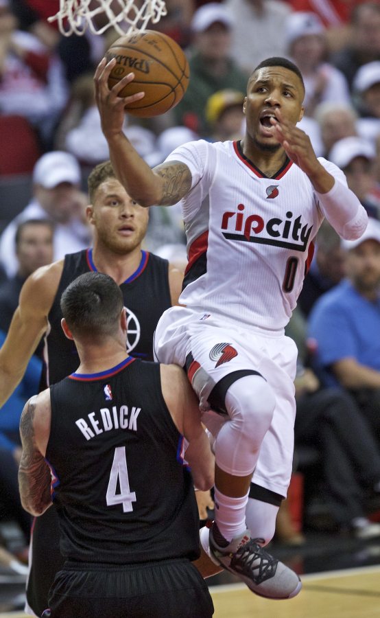 Portland&#039;s Damian Lillard (0) shoots over Los Angeles Clippers&#039; J.J. Redick during the second half of Game 3.