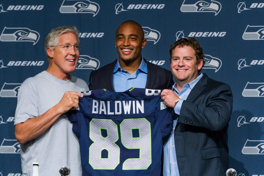 Seahawks Seahawks coach Pete Carroll, left, wide receiver Doug Baldwin, center, and general manager John Schneider for a photo with Baldwin&#039;s jersey at a news conference in Renton, Wash., on Thursday, May 29, 2014. Baldwin signed an extension that will keep him with the Seahawks through the 2016 season. Baldwin will play the 2014 season under the second-round tender he received as a restricted free agent then will receive two additional years.