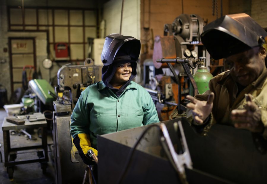 Women Who Weld lead instructor Ralph Taylor talks with Daniela Hagen while describing the proper way to weld at the Addison Iron Fabricators in Detroit.