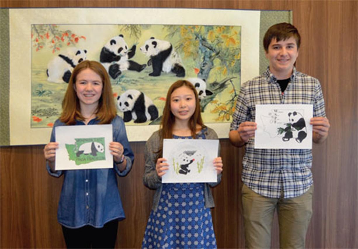 North Salmon Creek: Annika Carlson, from left, Jennifer Chun, and Stefan Zucktriegel pose with their logo designs for the Washington State Panda Foundation.