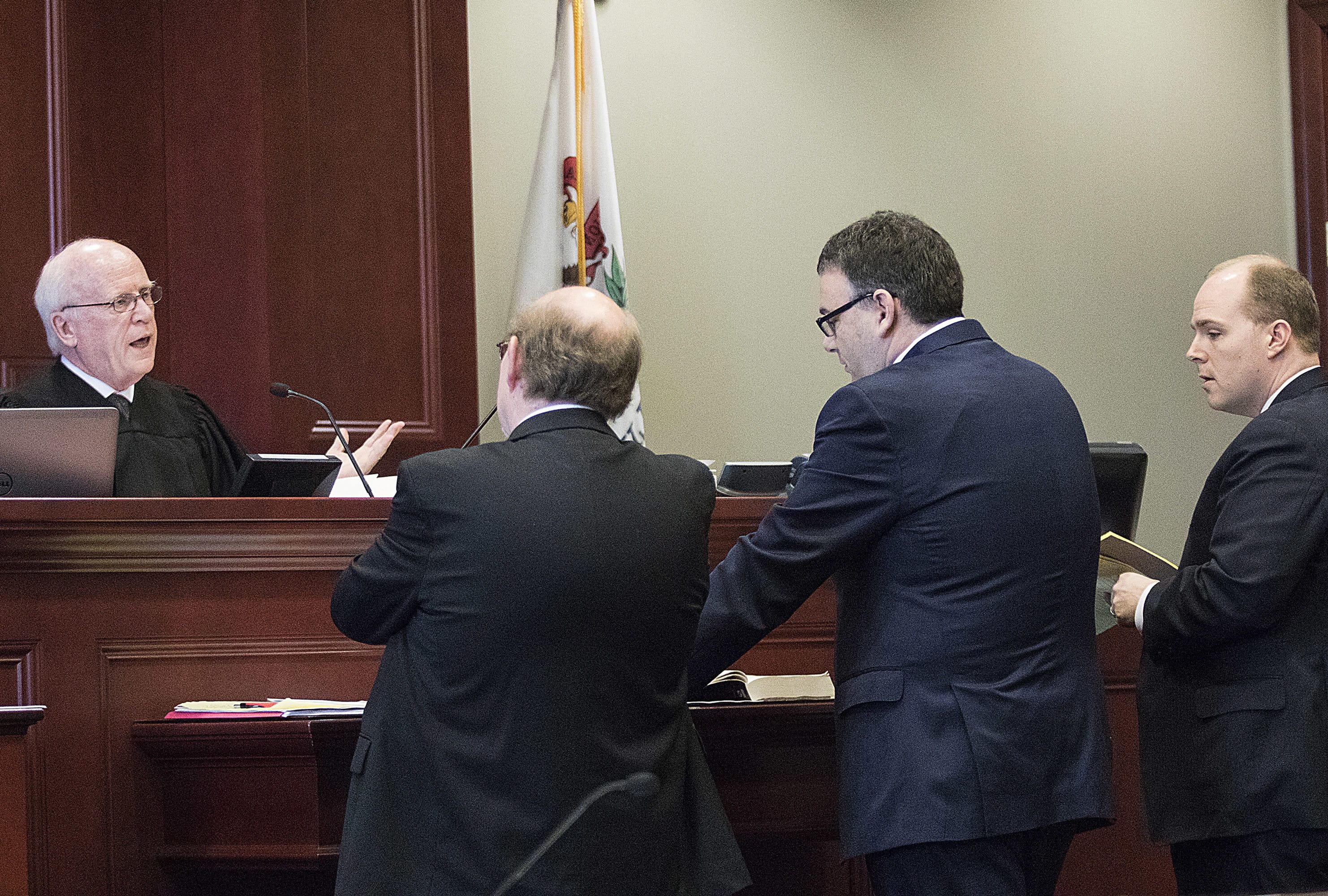 DeKalb County Judge William Brady, from left, speaks Friday to DeKalb County State&#039;s Attorney Richard Schmack and attorneys Gabriel Fuentes and Shaun Van Horn in Sycamore, Ill., after Fuentes and Van Horn filed a motion Thursday requesting Brady vacate their client Jack McCullough&#039;s murder conviction or release him on bond. McCullough was convicted in 2012 for the 1957 killing of 7-year-old Maria Ridulph, of Sycamore.
