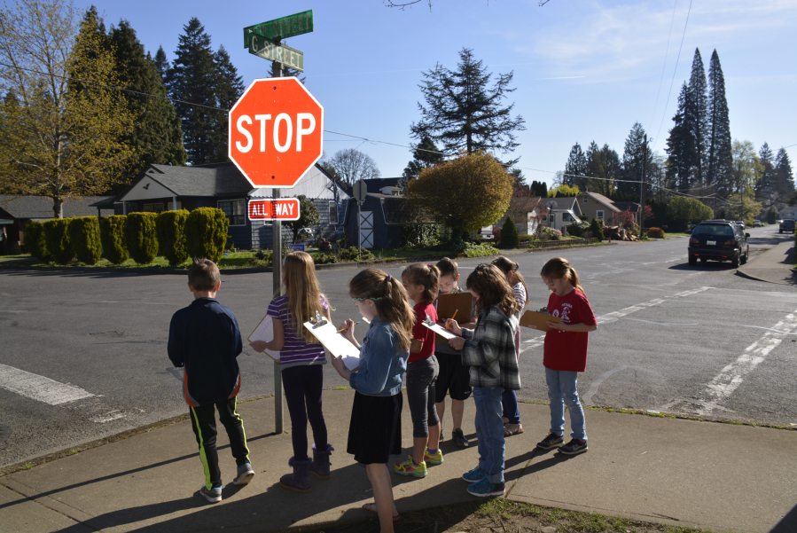 Hathaway Elementary students from Debbie Kramer&#039;s second-grade class study street signs and other city map features during a mapping activity April 18.