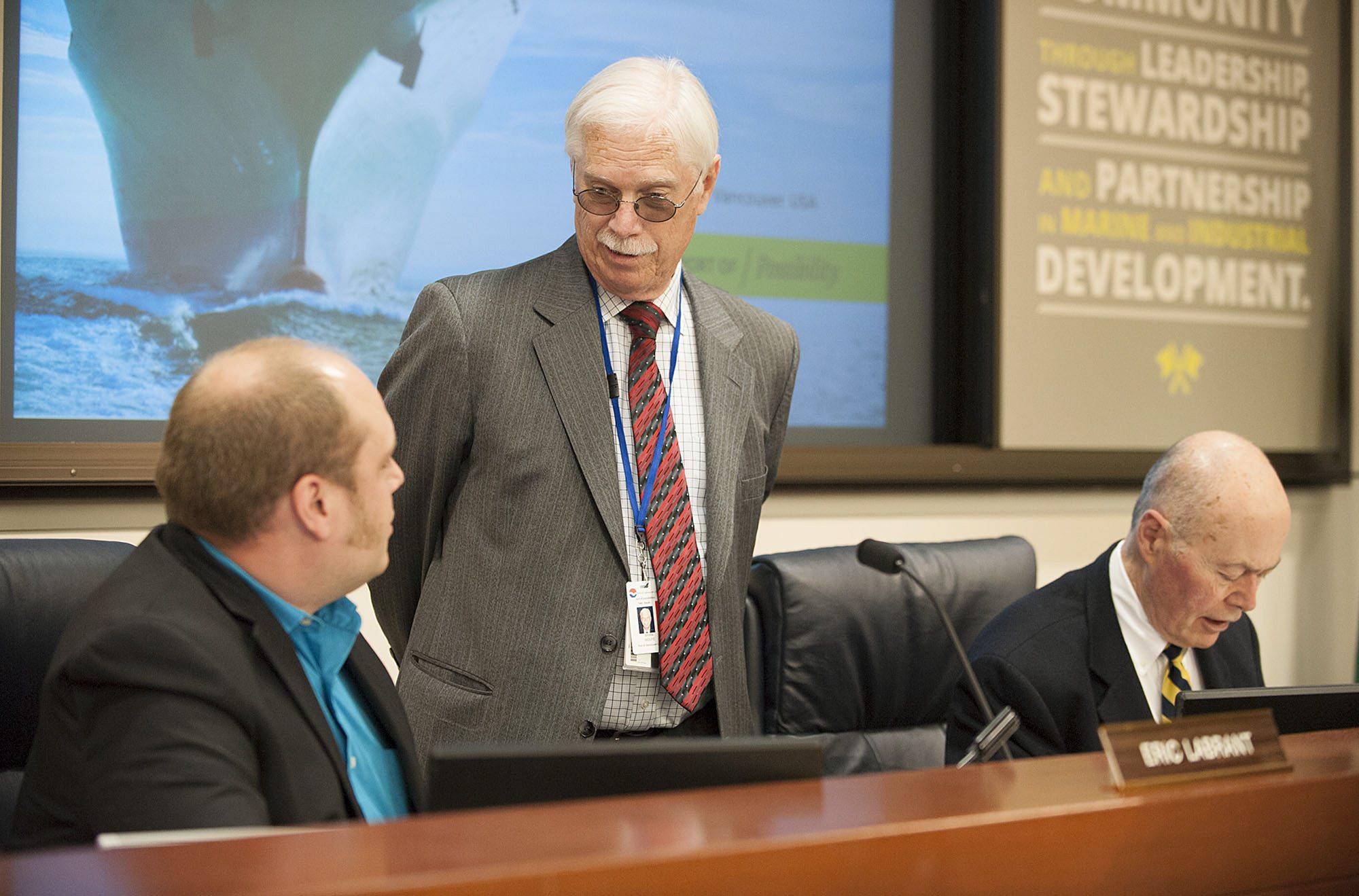 Port Commissioners Eric LaBrant, from left, and Brian Wolfe chat before the meeting as fellow Commissioner Jerry Oliver works nearby Friday afternoon, April 15, 2016 at the Port of Vancouver.