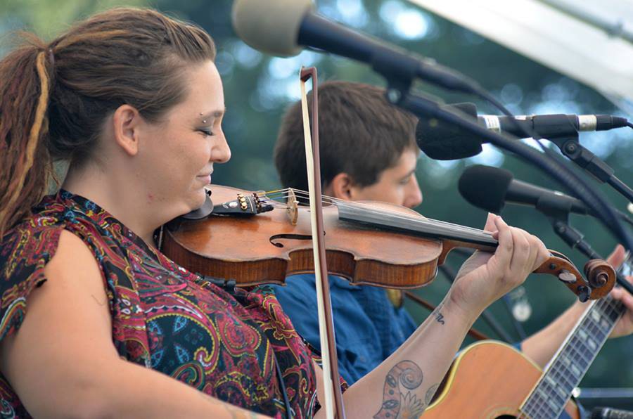Aarun Carter plays fiddle on stage with Jonathan Trawick at the Clark County Folk Festival.