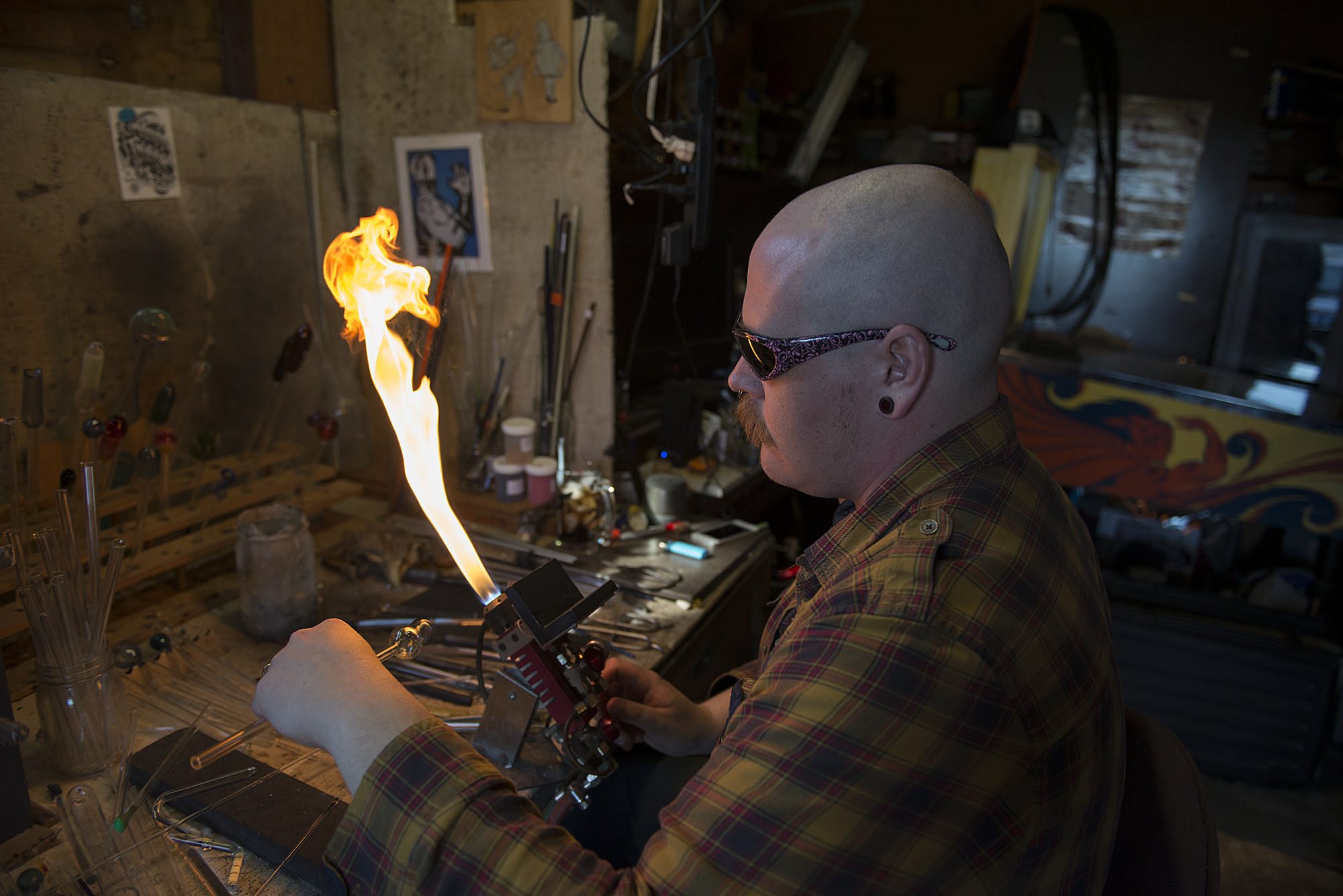 Jamie Jenkins of Brush Prairie uses a torch to manipulate glass while making a pipe.