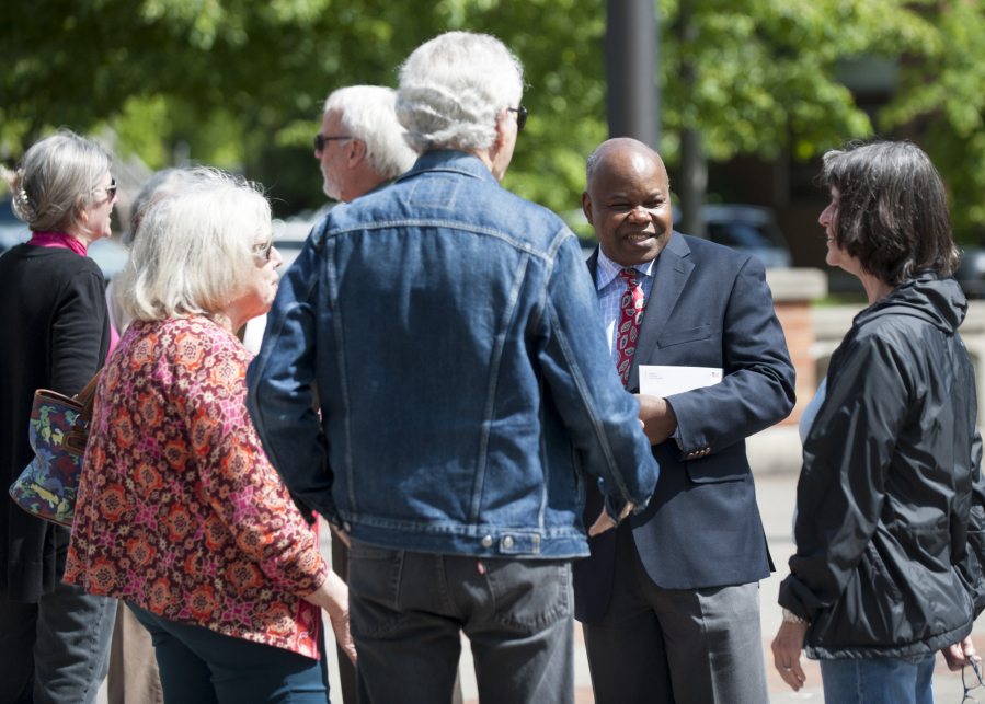 Clark County Community Planning Director Oliver Orjiako, second from the right, is seen surrounded by friends and supporters Tuesday outside the Public Service Center in downtown Vancouver. Clark County Councilor David Madore has accused Orjiako of lying about the county&#039;s growth plan.