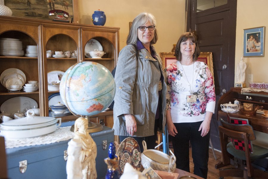 Second Hand Solutions store manager Julie Murray, right, with Judy McMorine, Open House Ministries development director, talk about the new vintage and antique shop opened at the nonprofit&#039;s retail building.