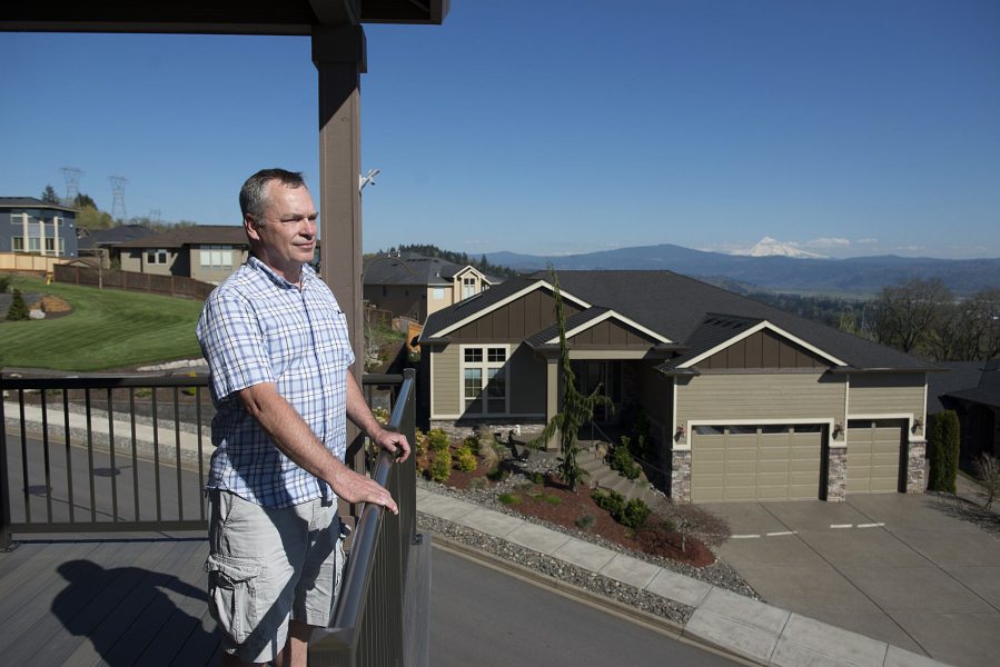 Bill Campbell takes in the view from his deck. He said he thinks the government should bury the proposed high-voltage power line to preserve views and property values, and to protect the environment.