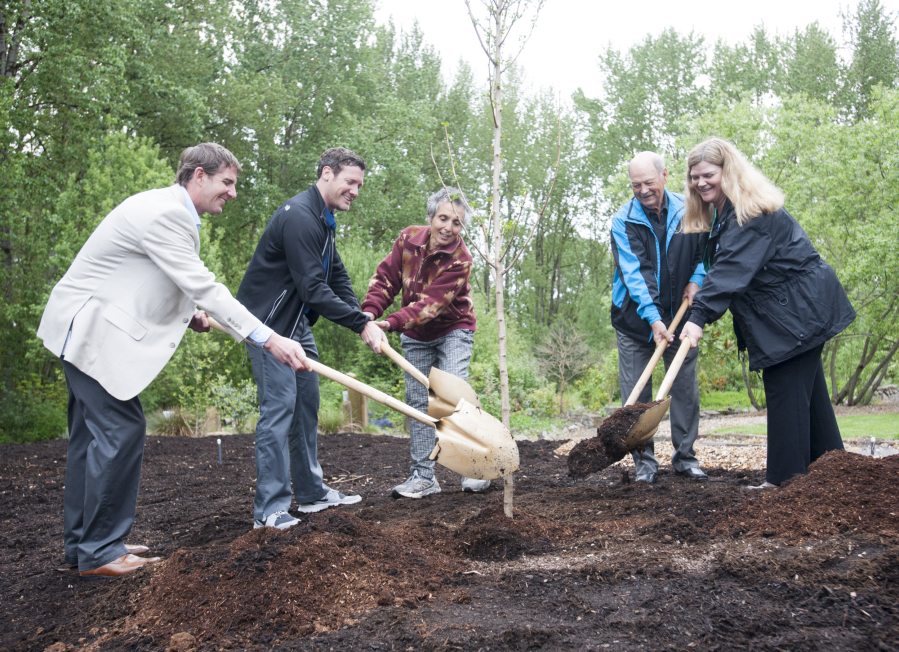 Aaron Everett of the Washington State Department of Natural Resources, from left; Vancouver Mayor Tim Leavitt; Cory Samia, the city&#039;s water and wetlands educator; urban forestry commissioner Dale Erickson; and Annette Griffy, stormwater engineering manager, plant a ginkgo tree Wednesday for Arbor Day at the Water Resources Education Center in Vancouver.