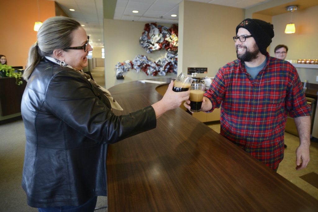 Betsy Henning, left, shares a drink with co-worker Nicholas Arnold at AHA, a Vancouver creative agency, in 2016.