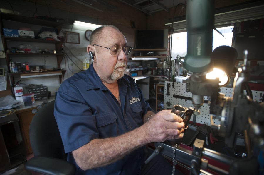 Don Sutton of The Sharp Shop, a home-based business, sharpens a drill bit in east Vancouver.