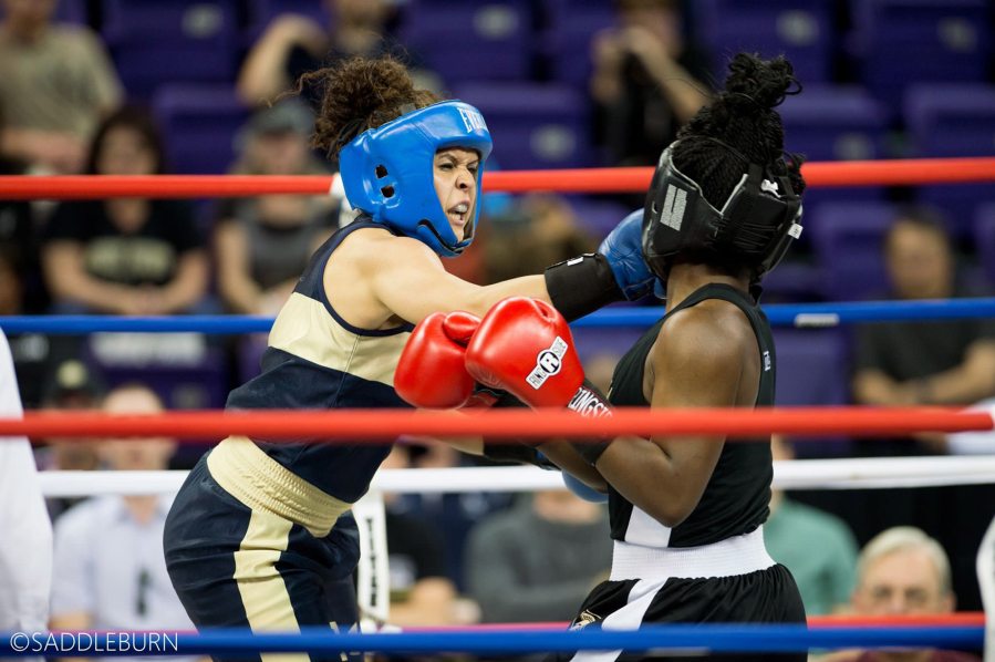 Stephanie Simon of Vancouver, left, delivers a punch to Ejakhain Obiomon of Army on her way to winning her second national college boxing title. (Kathryn S.