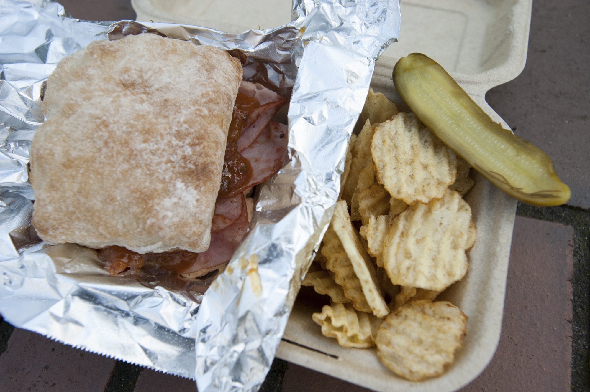 The Georgia Peach sandwich is served with chips and a pickle at the Pimento Cheese Kitchen food cart in Vancouver.