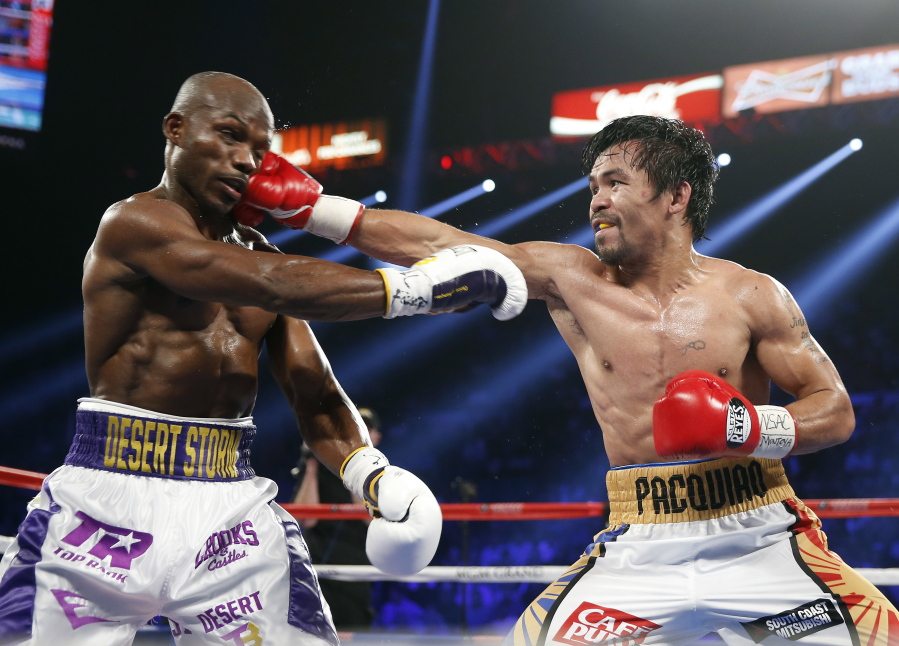 Manny Pacquiao, right, of the Philippines, hits Timothy Bradley during their WBO welterweight title boxing bout Saturday, April 9, 2016, in Las Vegas.