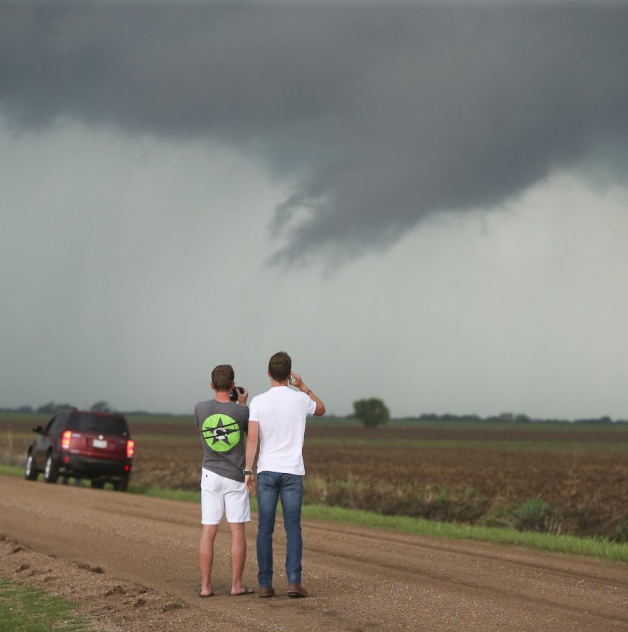 Storm chasers photograph storm clouds near Wellington, Kan., Tuesday. Thunderstorms bearing hail as big as grapefruit and winds approaching hurricane strength lashed portions of the Great Plains on Tuesday.