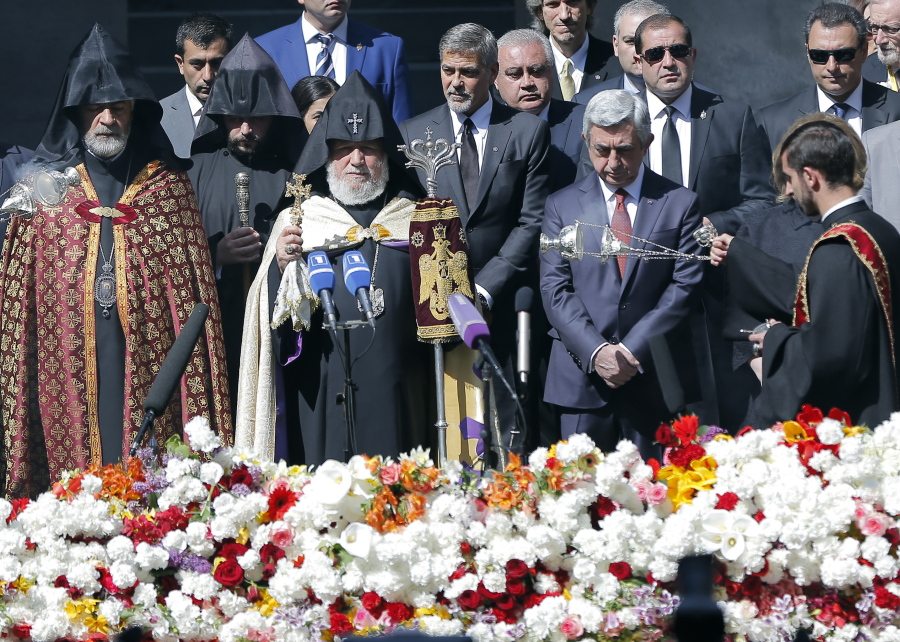 Armenian clergymen, U.S. actor George Clooney, center, Armenian President Serzh Sargsyan, second right front, and guests attend a ceremony at a memorial to Armenians killed by the Ottoman Turks, in Yerevan, Armenia, on Sunday.