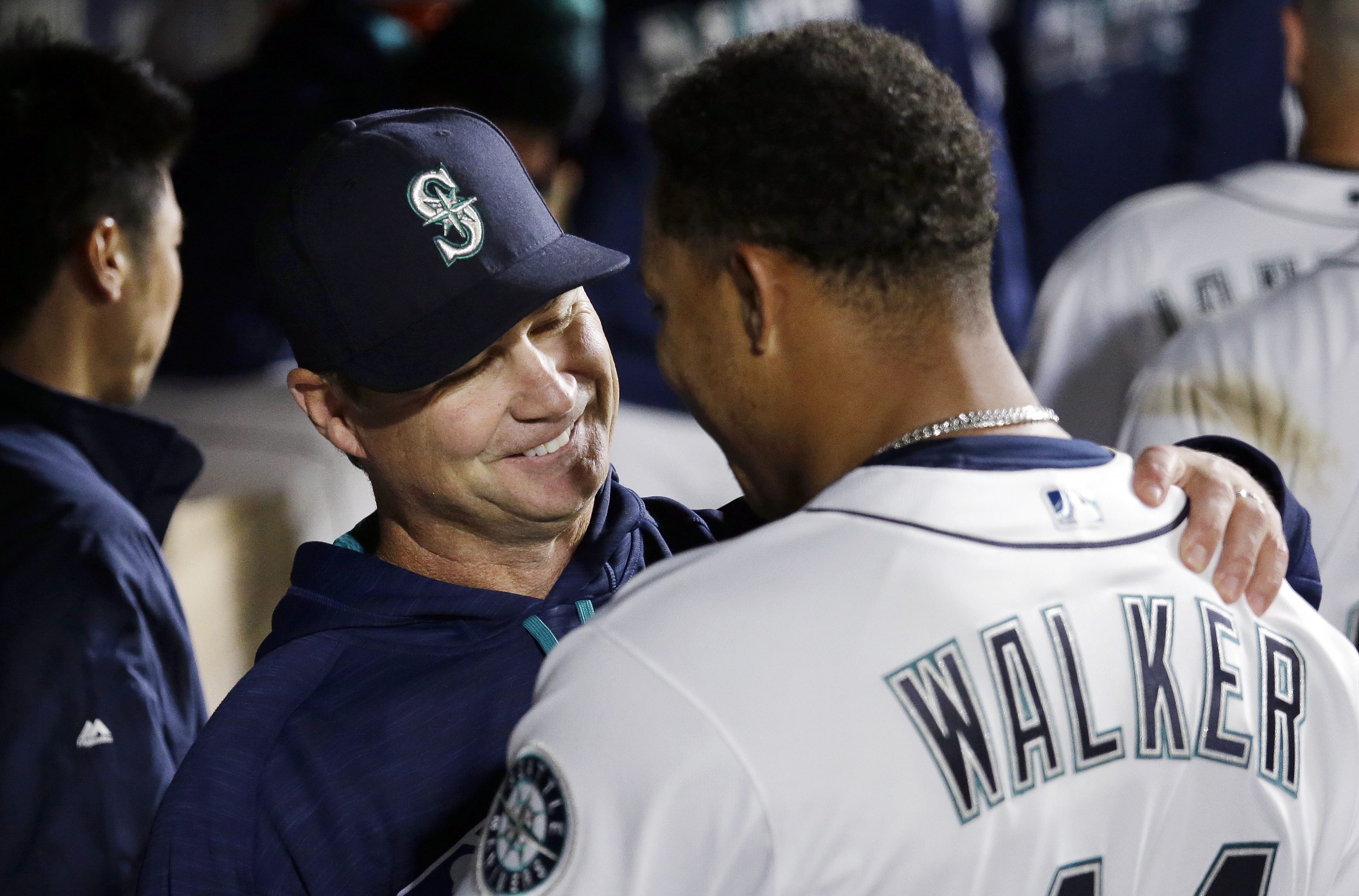 Seattle Mariners manager Scott Servais, left, embraces starting pitcher Taijuan Walker after Walker struck out the Houston Astros side in the seventh inning of a baseball game Monday, April 25, 2016, in Seattle.